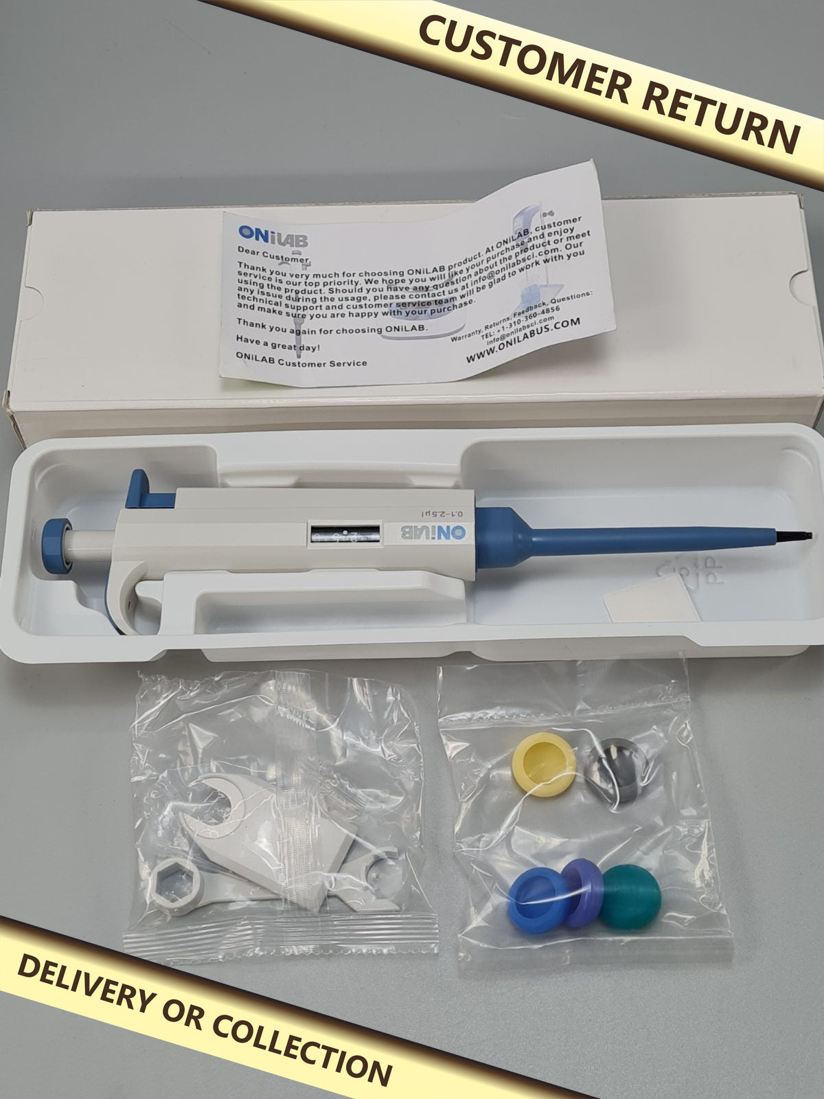 Single channel pipettor — photograph 1 — Customer return; auction delivery information shown on image