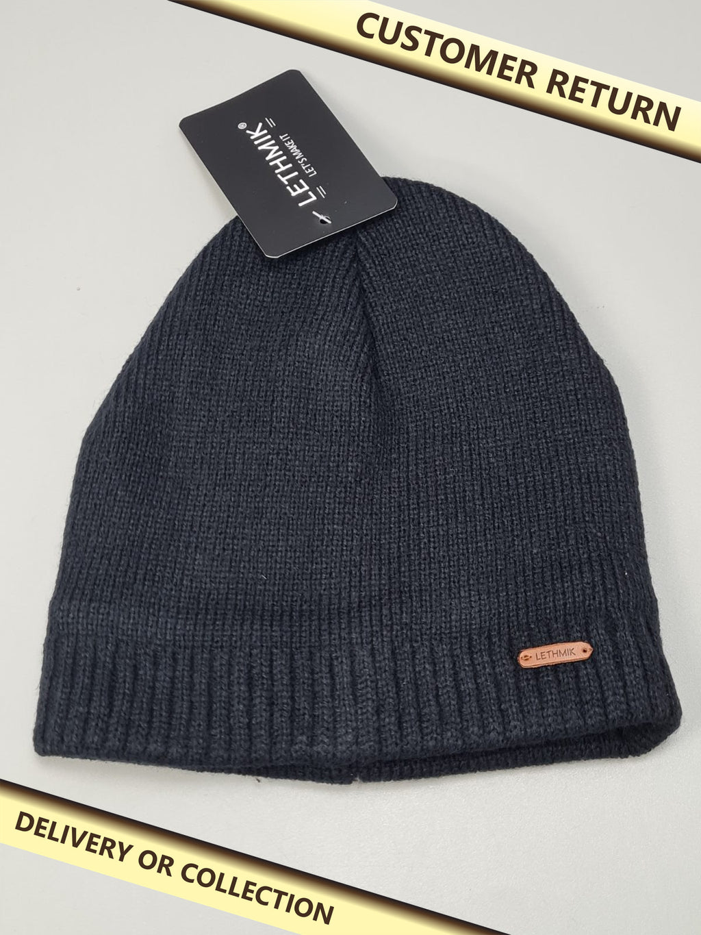 Black beanie hat — photograph 1 — Customer return; auction delivery information shown on image