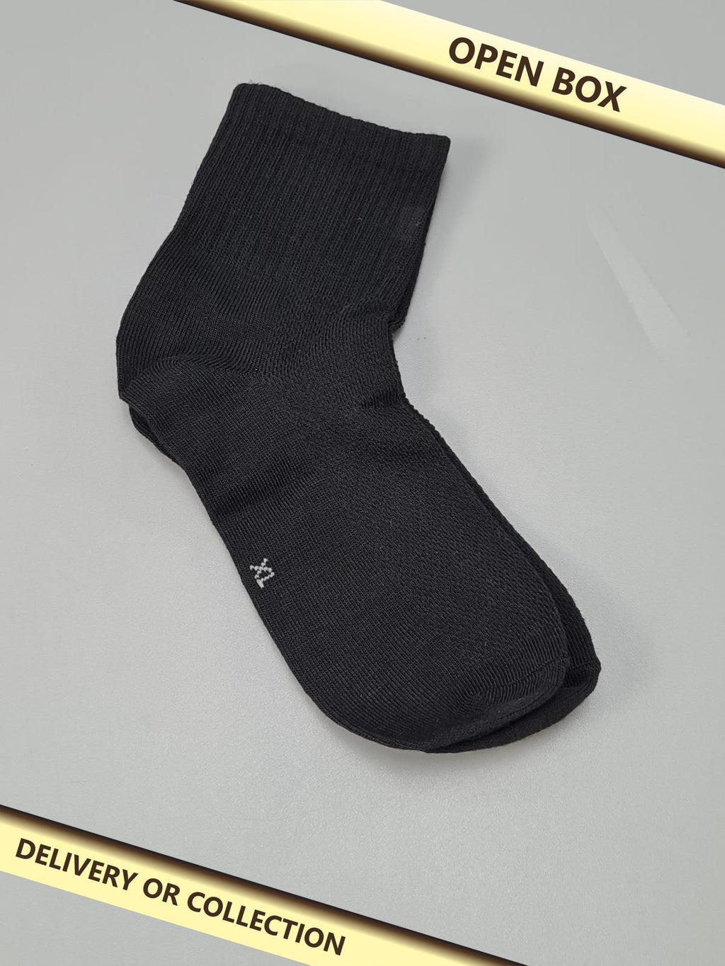 9 pairs of kids black socks — photograph 1 — Open box; auction delivery information shown on image