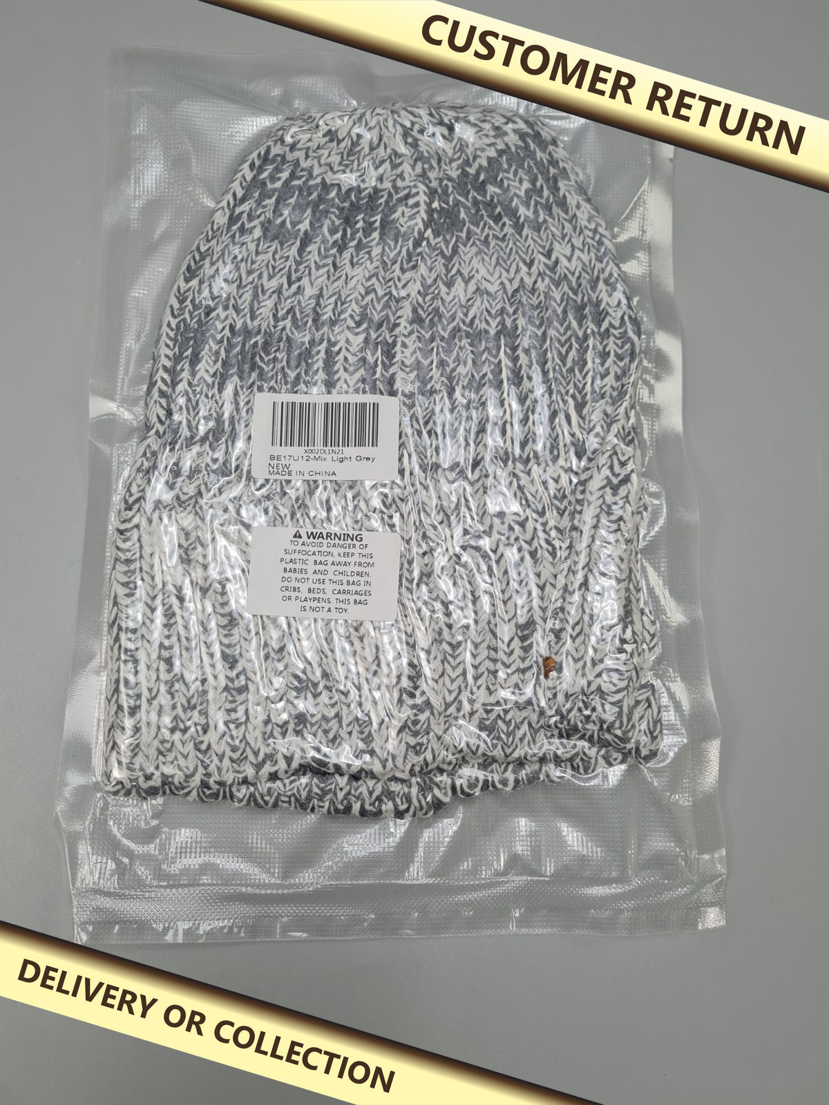 Light grey beanie hat — photograph 1 — Customer return; auction delivery information shown on image