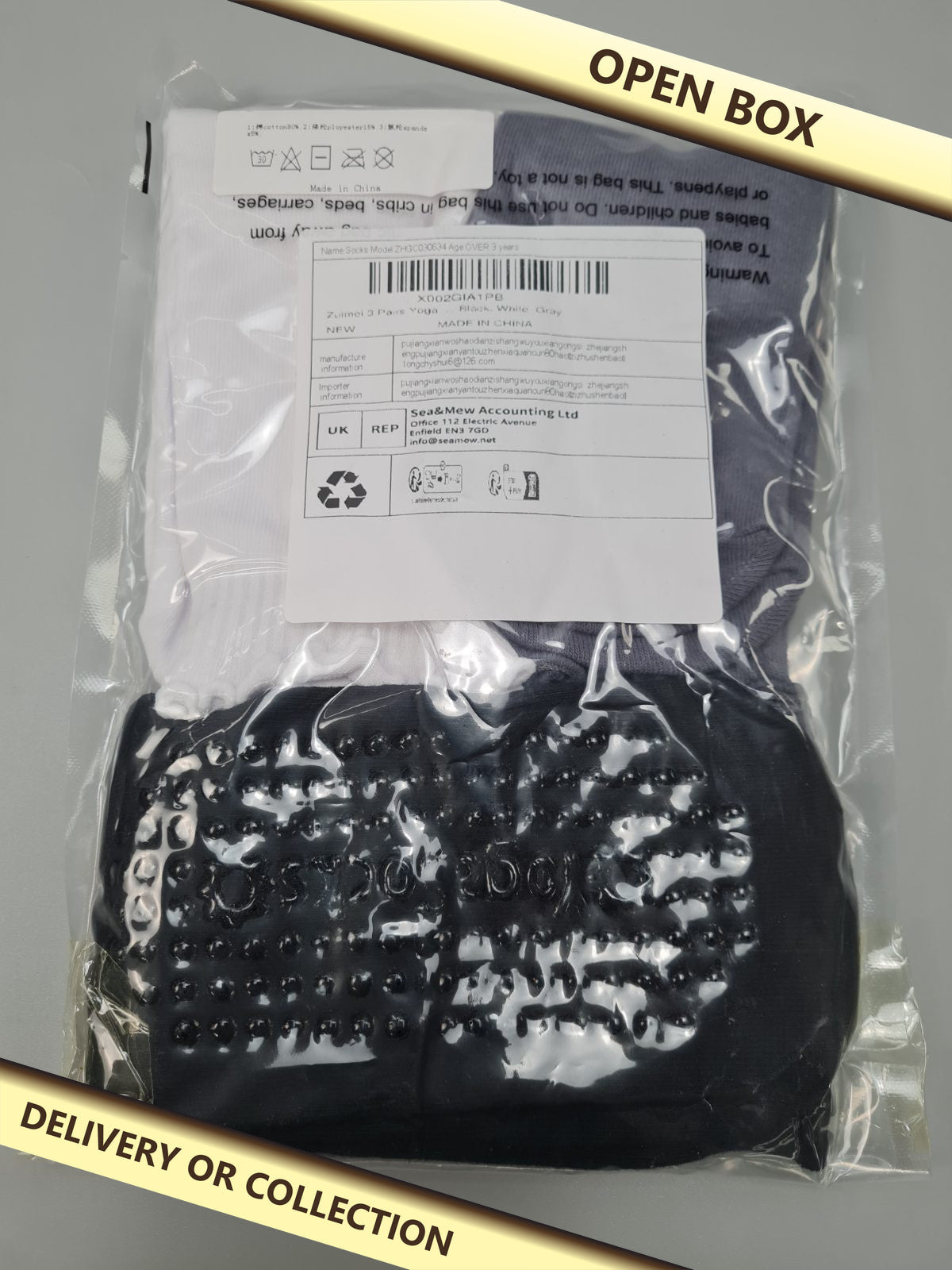 3 pairs of yoga socks — photograph 1 — Open box; auction delivery information shown on image