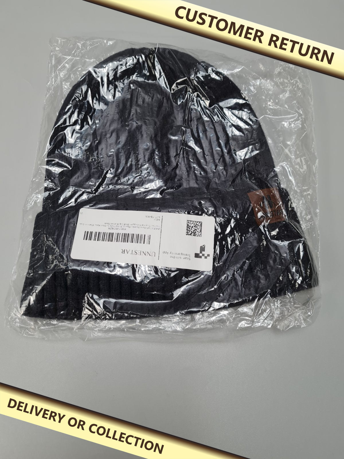 Black knitted winter hat — photograph 1 — Customer return; auction delivery information shown on image