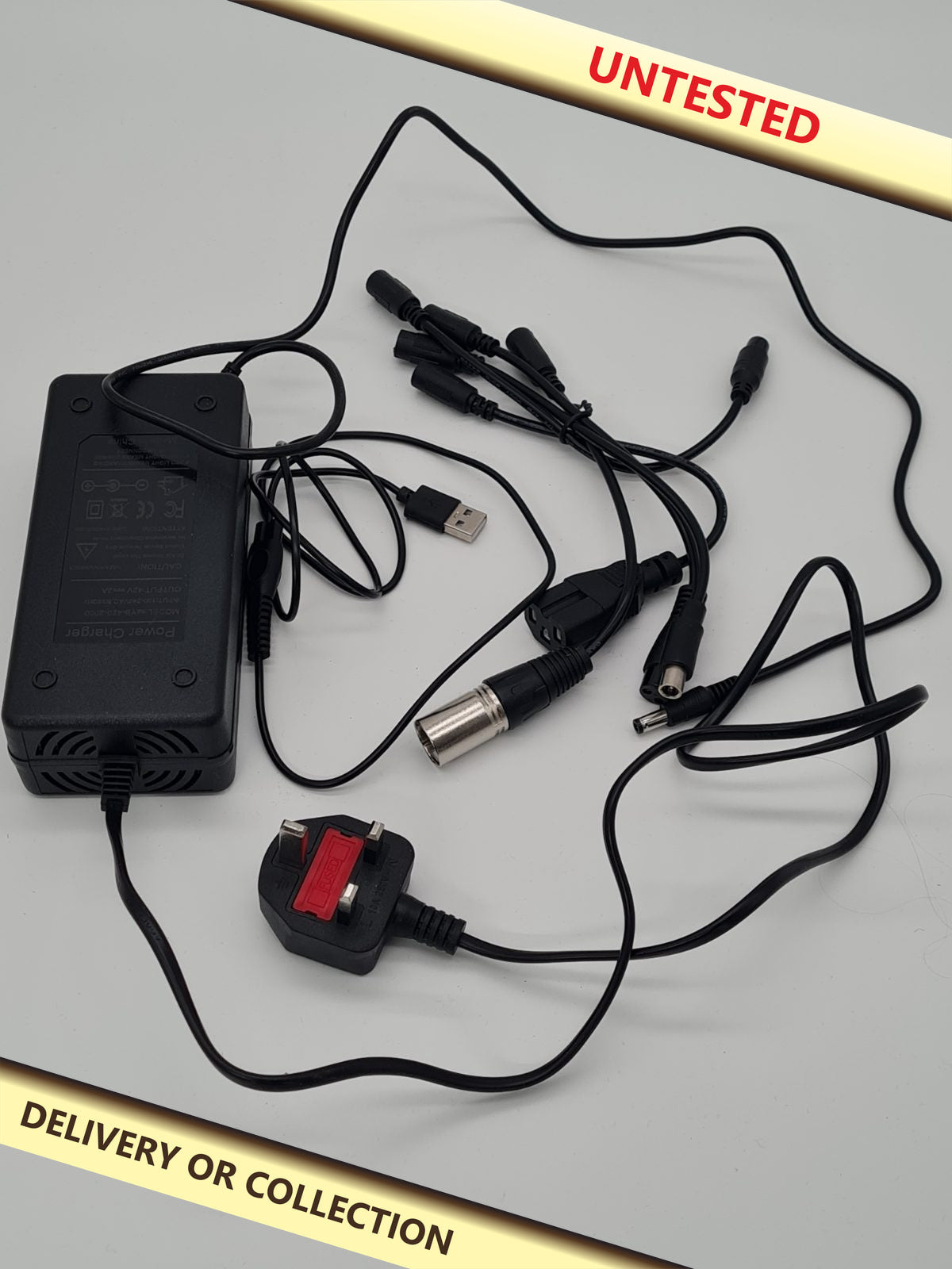Universal multi-connector battery charger. — photograph 1 — Untested; auction delivery information shown on image