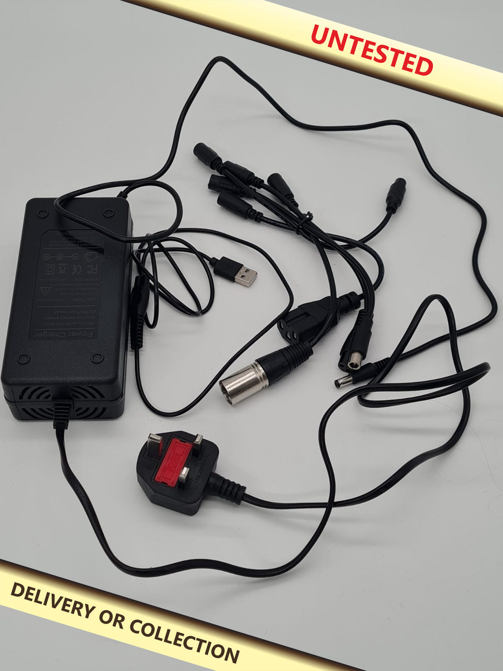 Universal multi-connector battery charger. — photograph 1 — Untested; auction delivery information shown on image