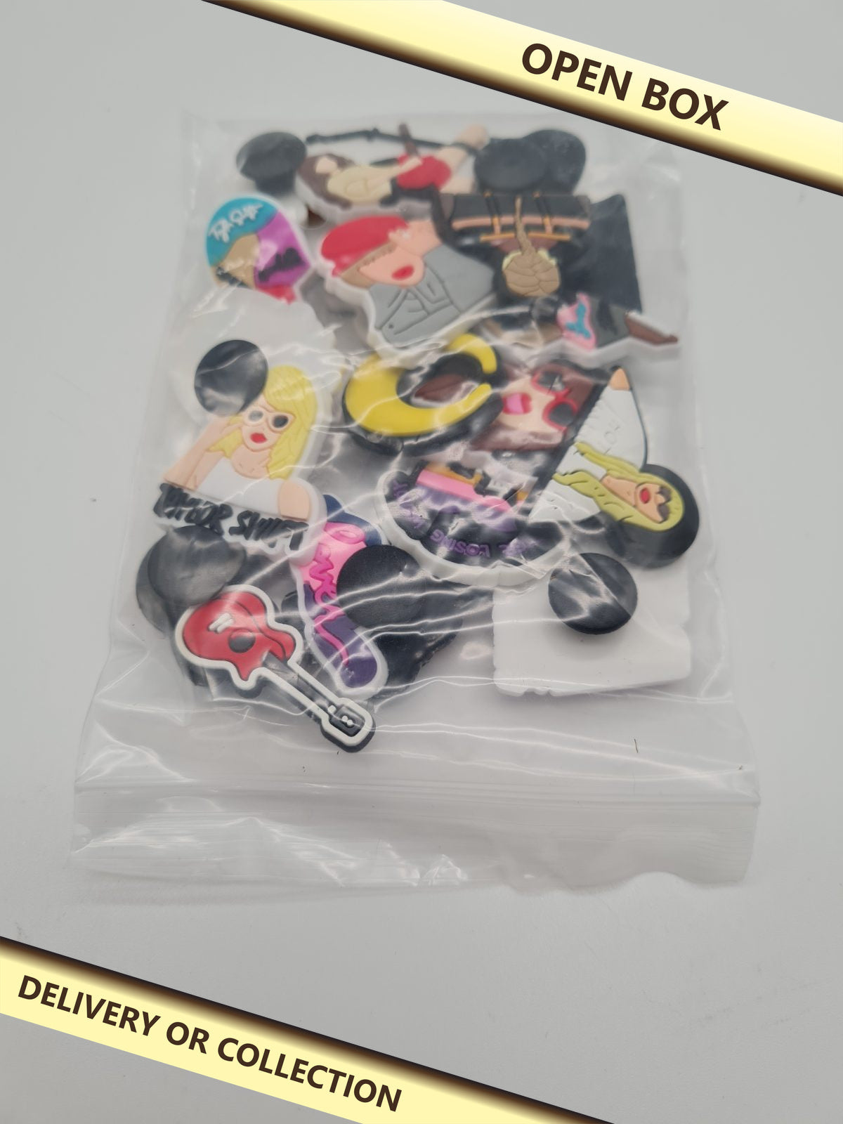 Assorted Decorative Shoe Charms — photograph 1 — Open box; auction delivery information shown on image