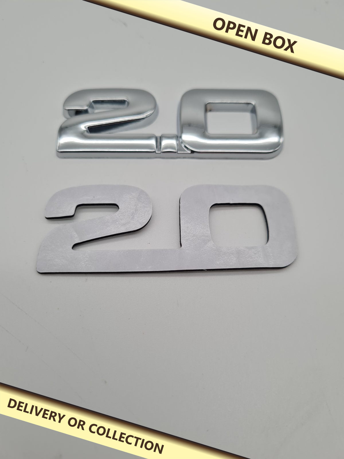 2.0 Car Adhesive Badge Emblem — photograph 1 — Open box; auction delivery information shown on image