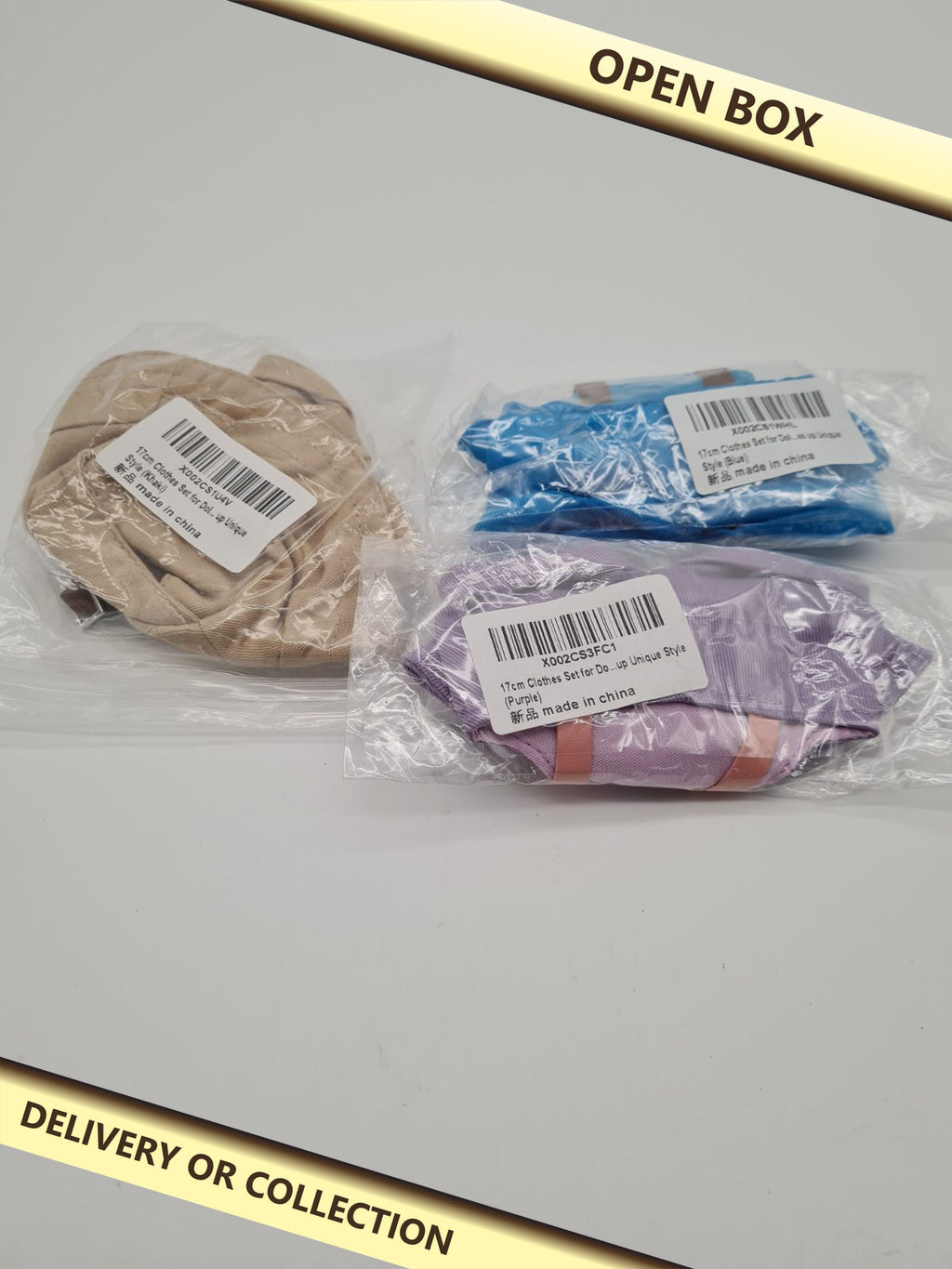 3 packs of clothes for dolls — photograph 1 — Open box; auction delivery information shown on image
