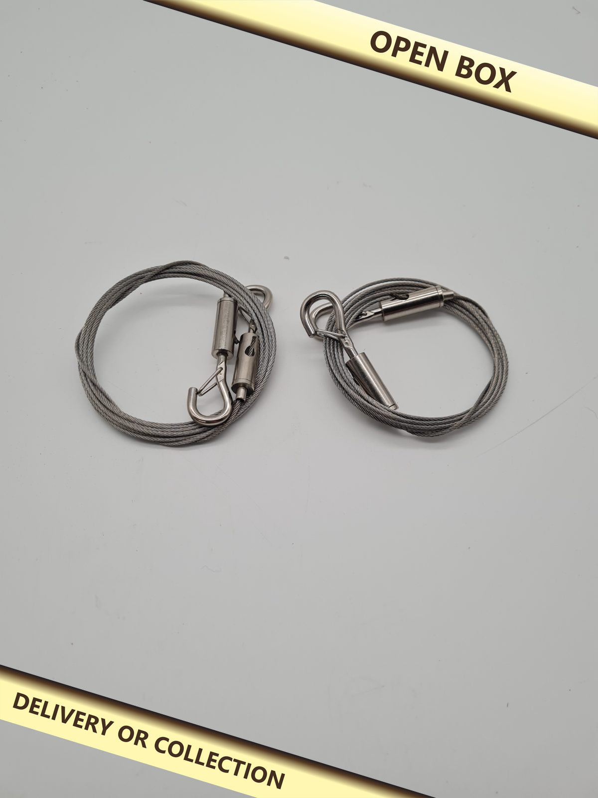 Pair of Adjustable Wire Hanging Cables 2 m x 1.5 mm — photograph 1 — Open box; auction delivery information shown on image