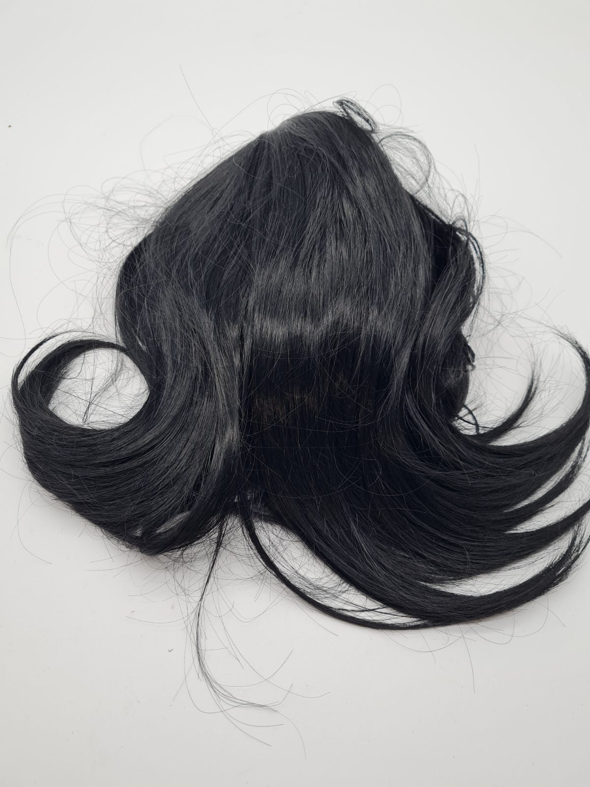 Short black curled hair piece — photograph 1