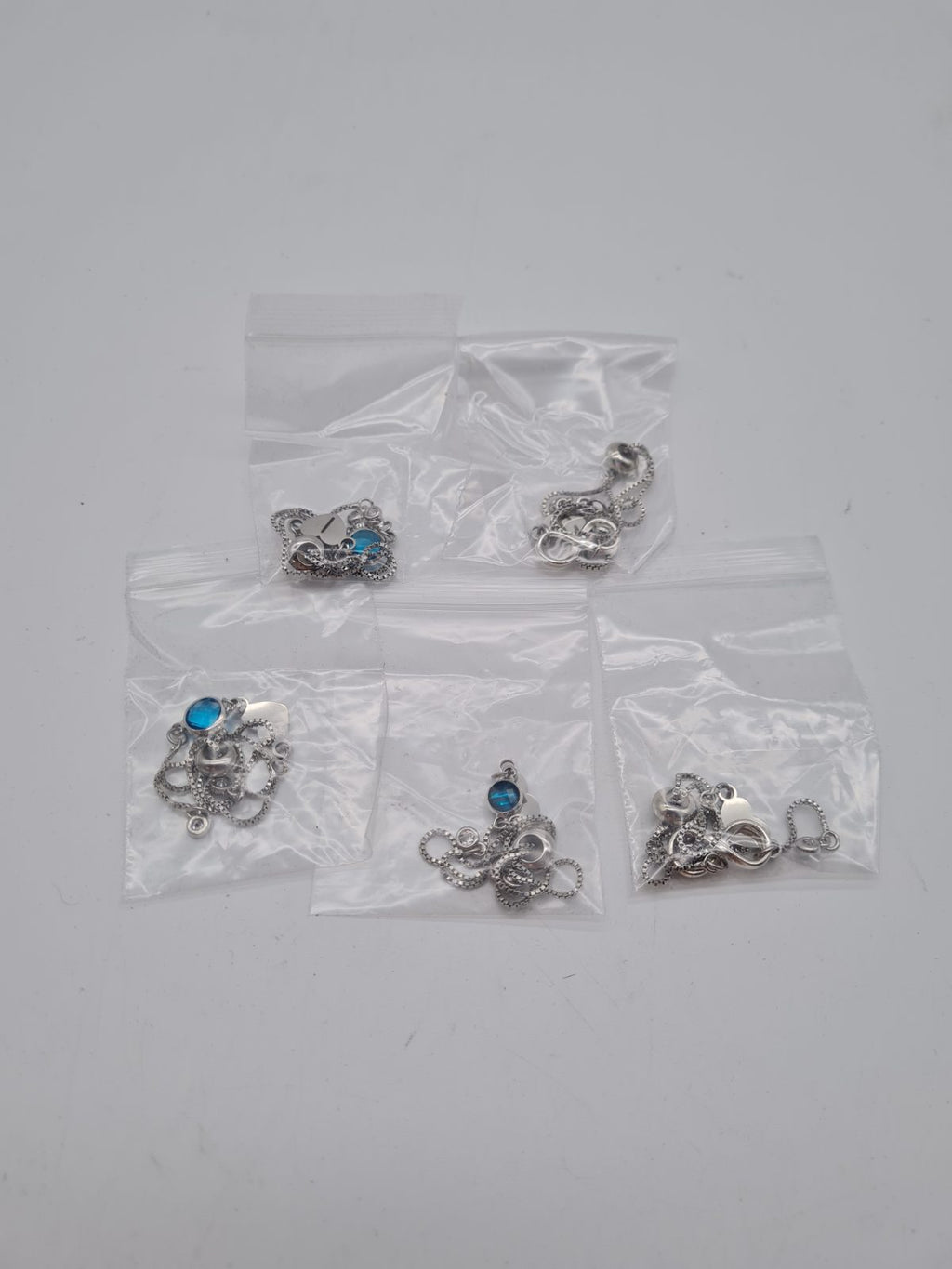 Set of Five Infinity Pendant Chain Bracelets — photograph 1