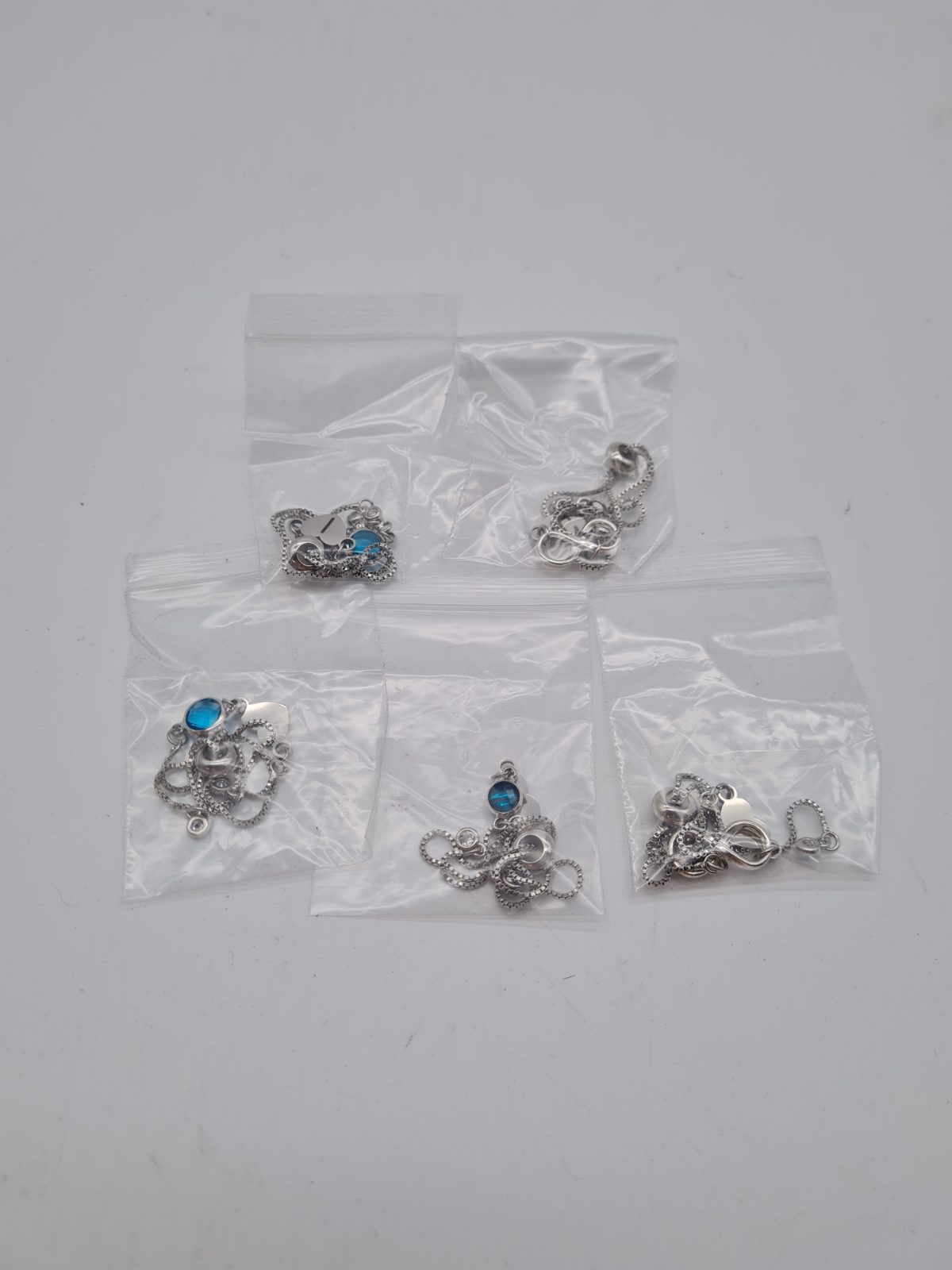 Set of Five Infinity Pendant Chain Bracelets — photograph 1