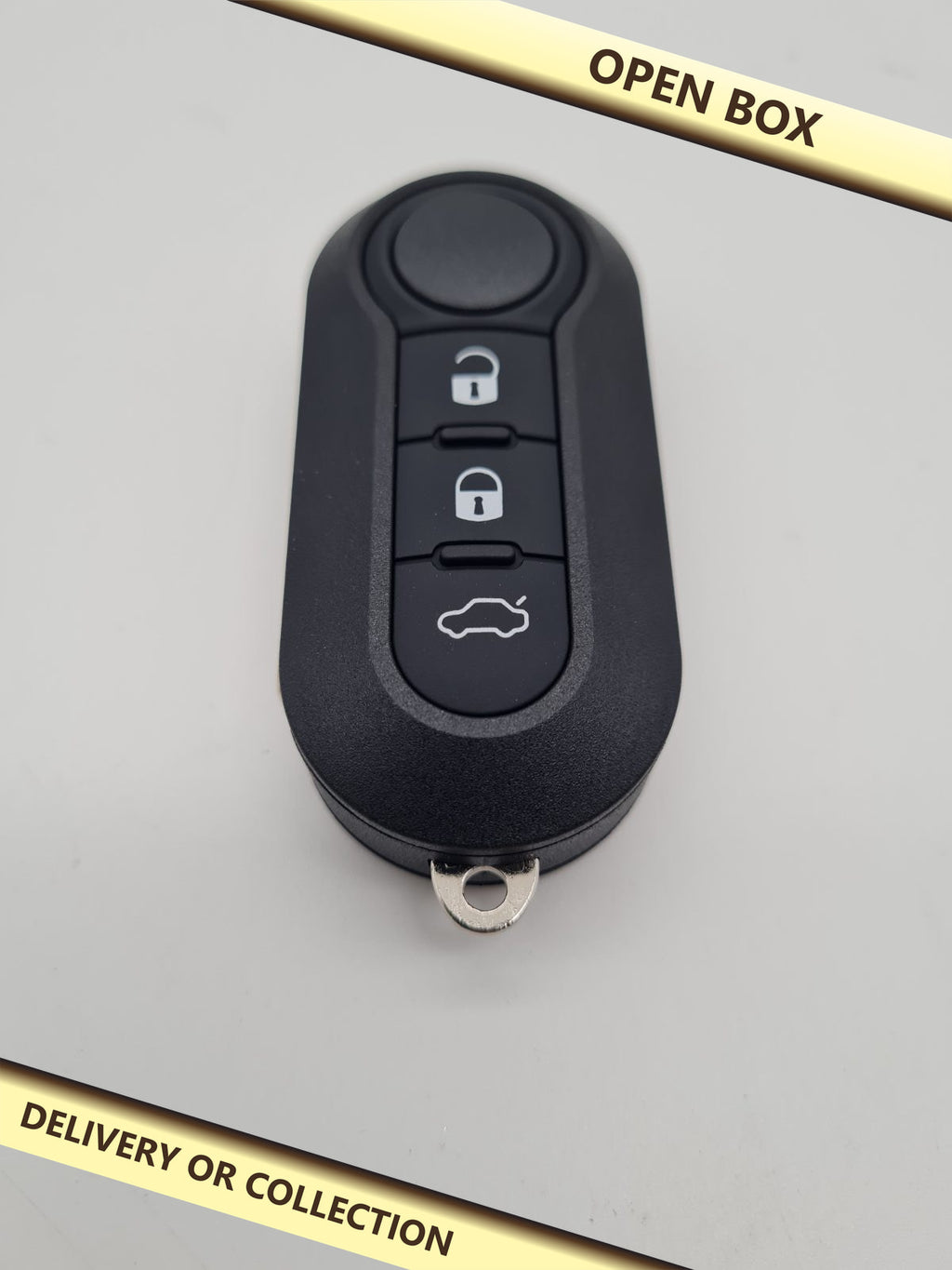 Three-Button Car Key Fob Shell with Uncut Blade — photograph 1 — Open box; auction delivery information shown on image