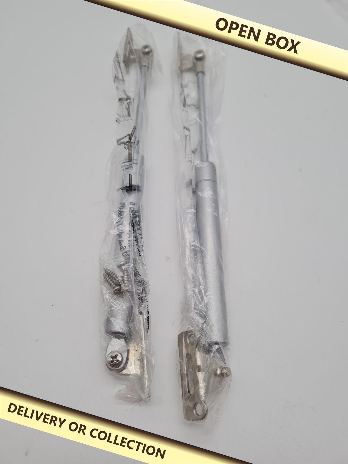 Pair of 120N Cabinet Door Gas Struts — photograph 1 — Open box; auction delivery information shown on image