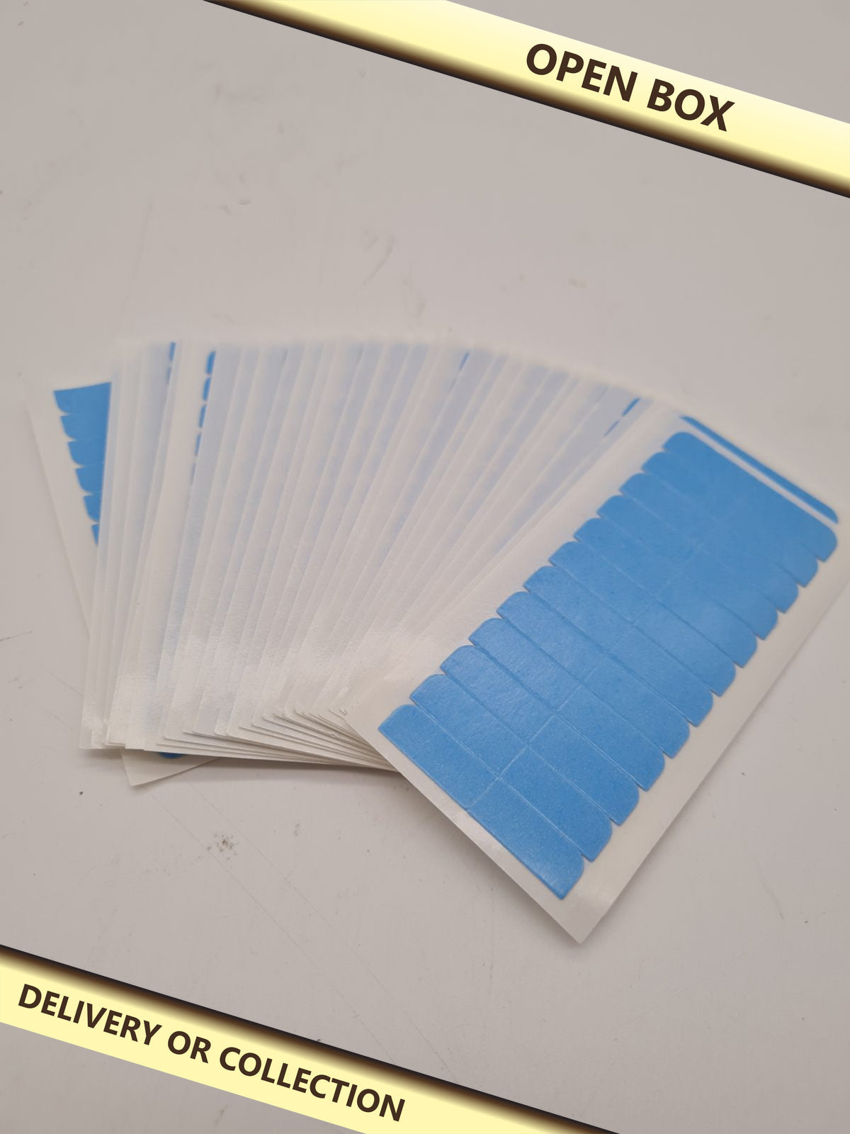 Pre-Cut Double-Sided Hair Extension Adhesive Tape Strips — photograph 1 — Open box; auction delivery information shown on image