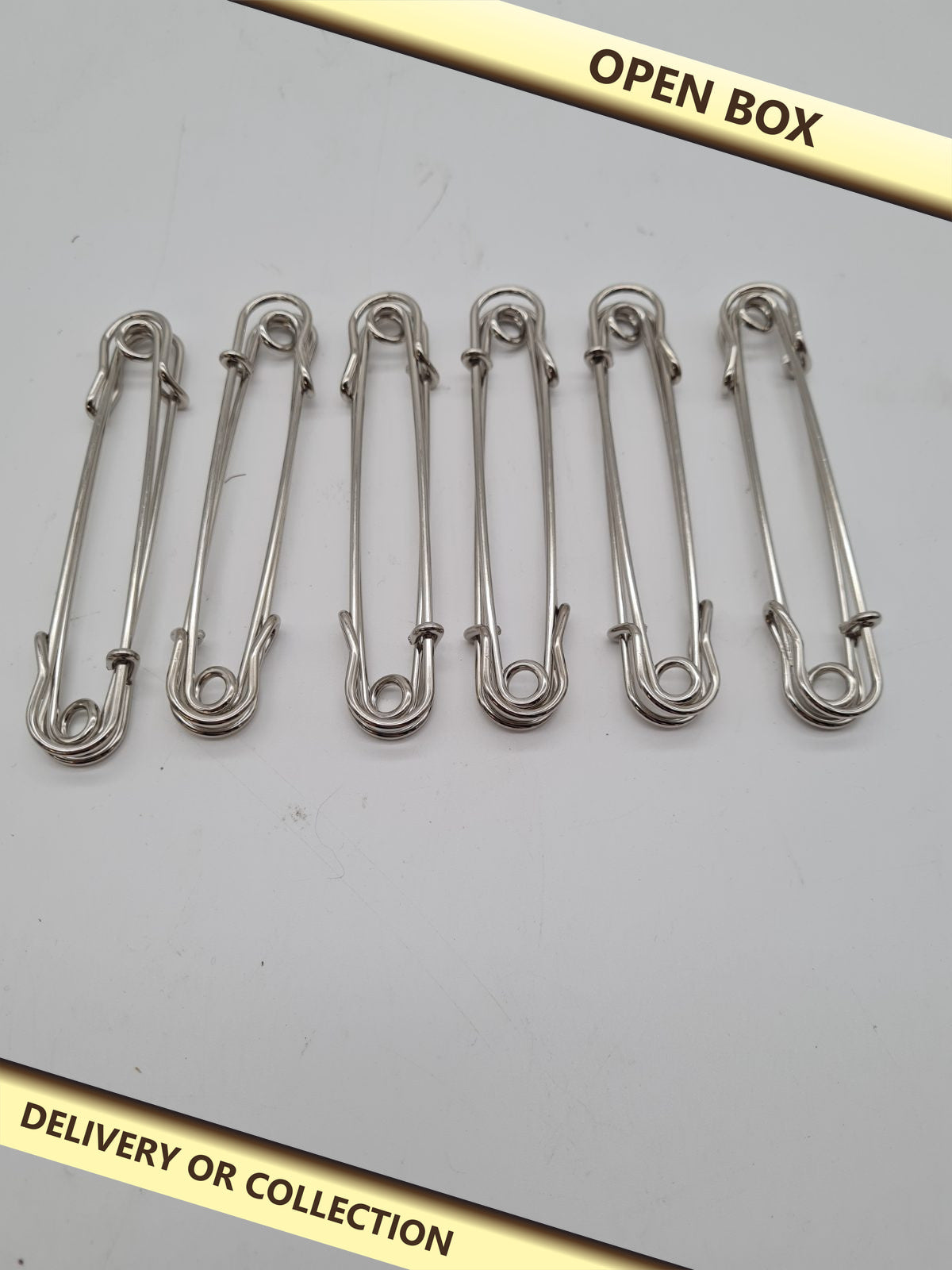 Set of 6 Large Safety Pins — photograph 1 — Open box; auction delivery information shown on image