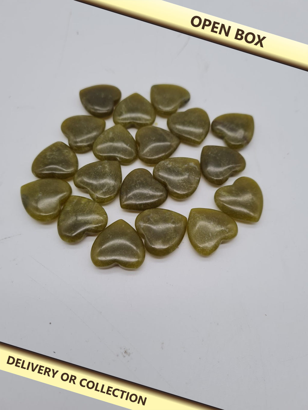 Set of  green 20 Heart-Shaped Polished Craft Stones — photograph 1 — Open box; auction delivery information shown on image