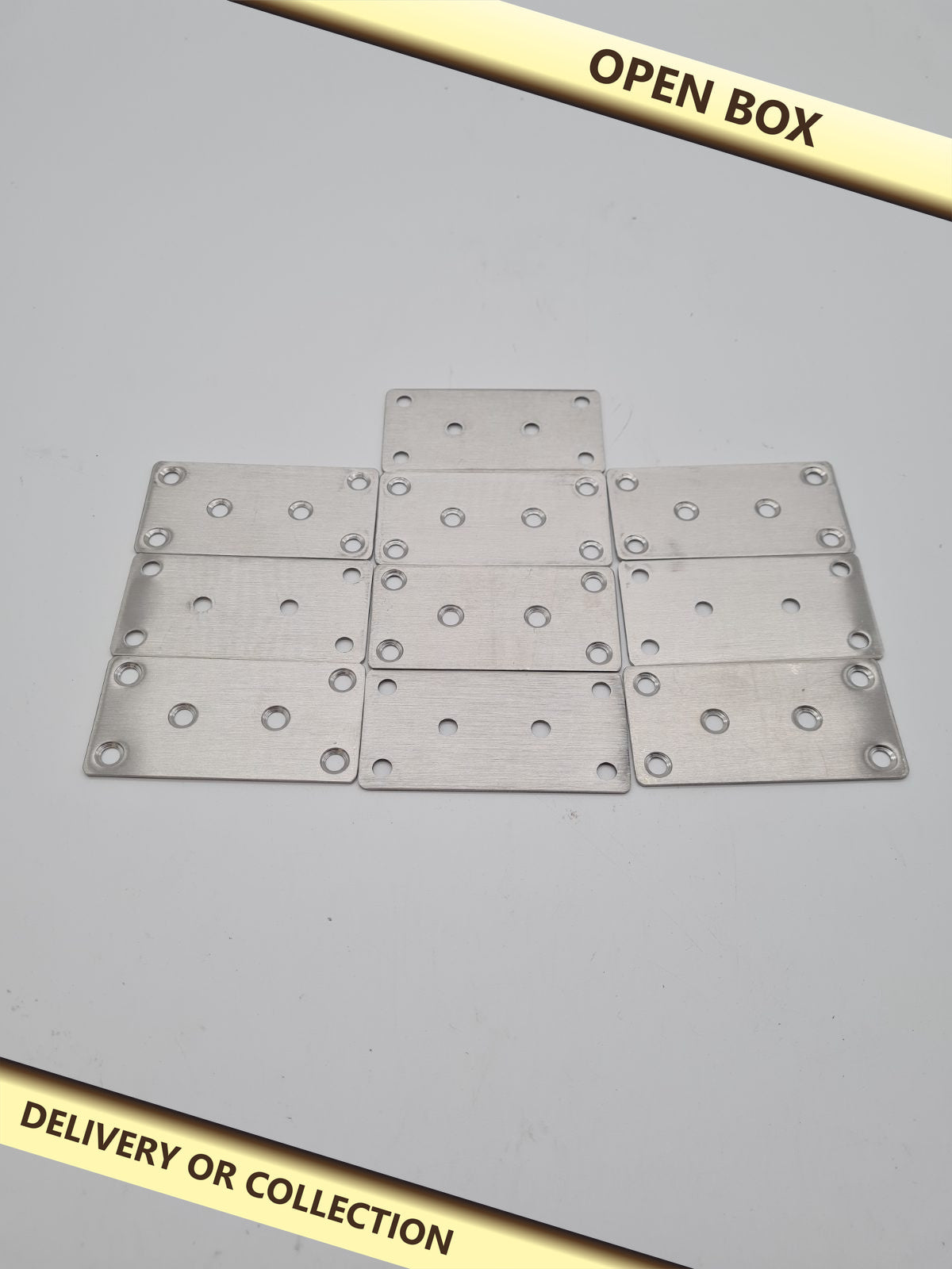10-Piece Flat Straight Metal Joining Plate Set 80mm x 40mm — photograph 1 — Open box; auction delivery information shown on image