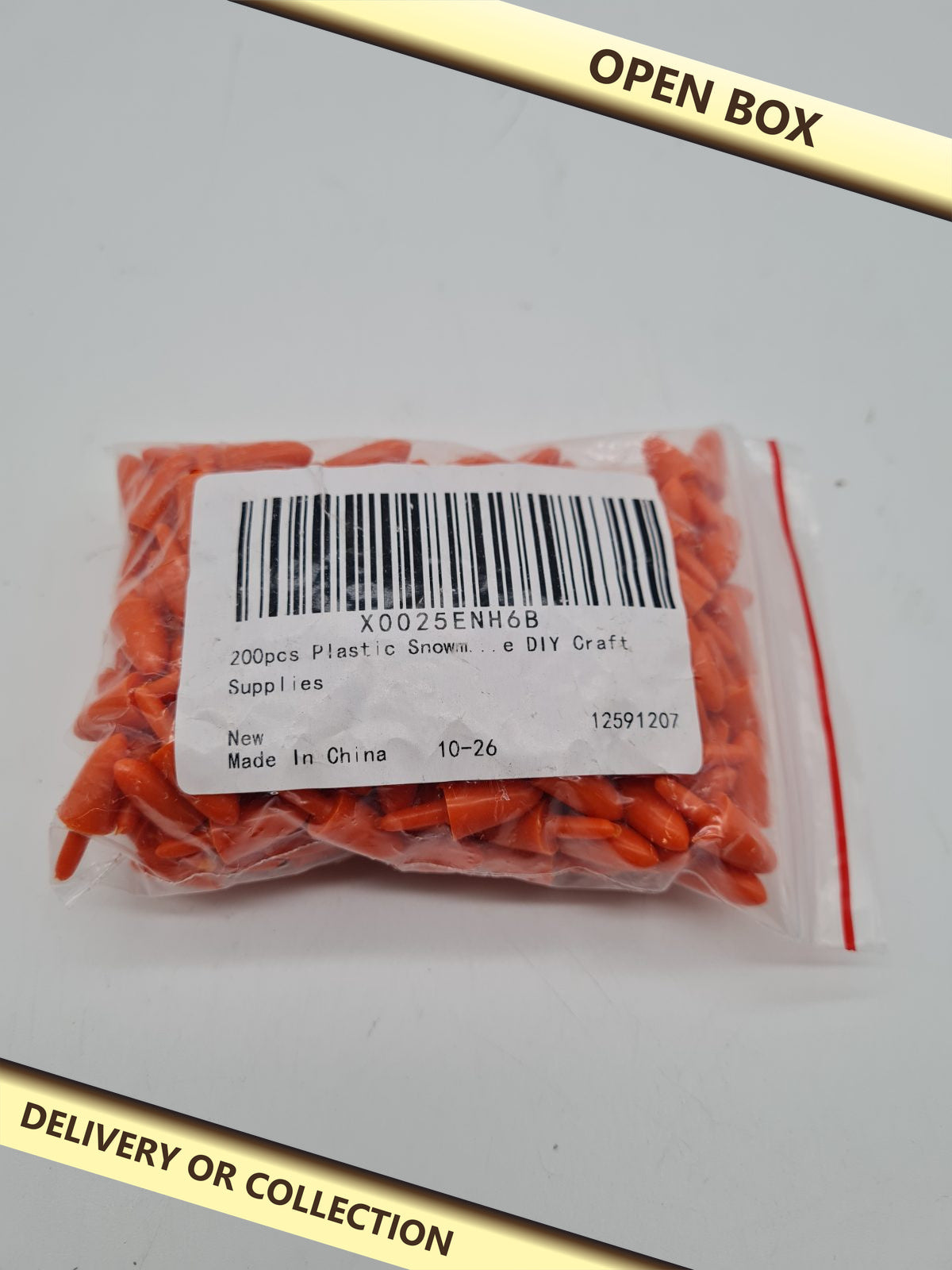 Plastic Snowman Nose Craft Pieces — photograph 1 — Open box; auction delivery information shown on image