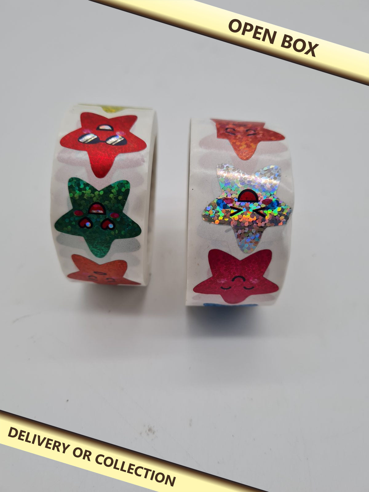 Two Rolls of Holographic Star Stickers — photograph 1 — Open box; auction delivery information shown on image