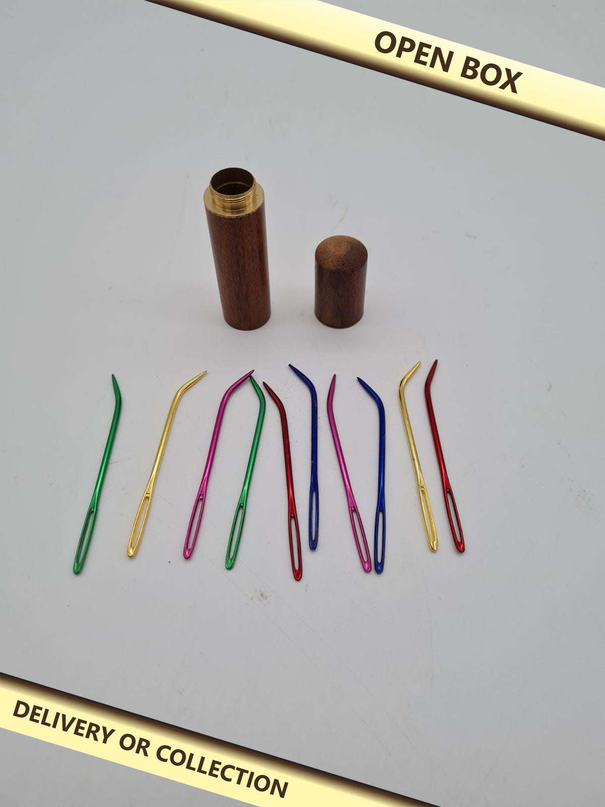 10 Large-Eye Hand Sewing Needles with Wooden Storage Case — photograph 1 — Open box; auction delivery information shown on image