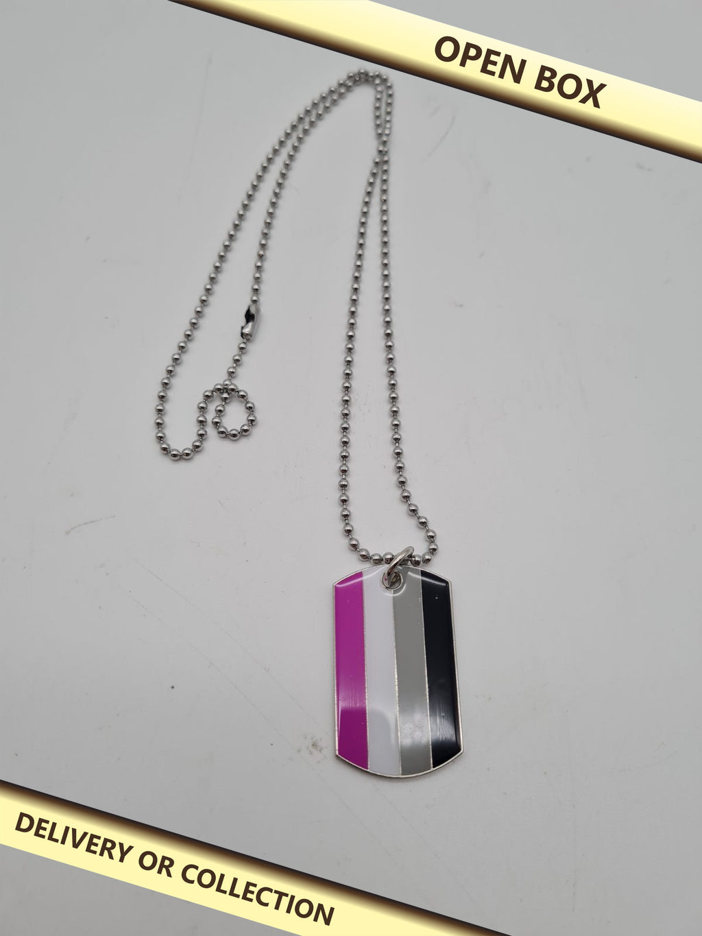 Pride Flag Dog Tag Pendant Necklace — photograph 1 — Open box; auction delivery information shown on image