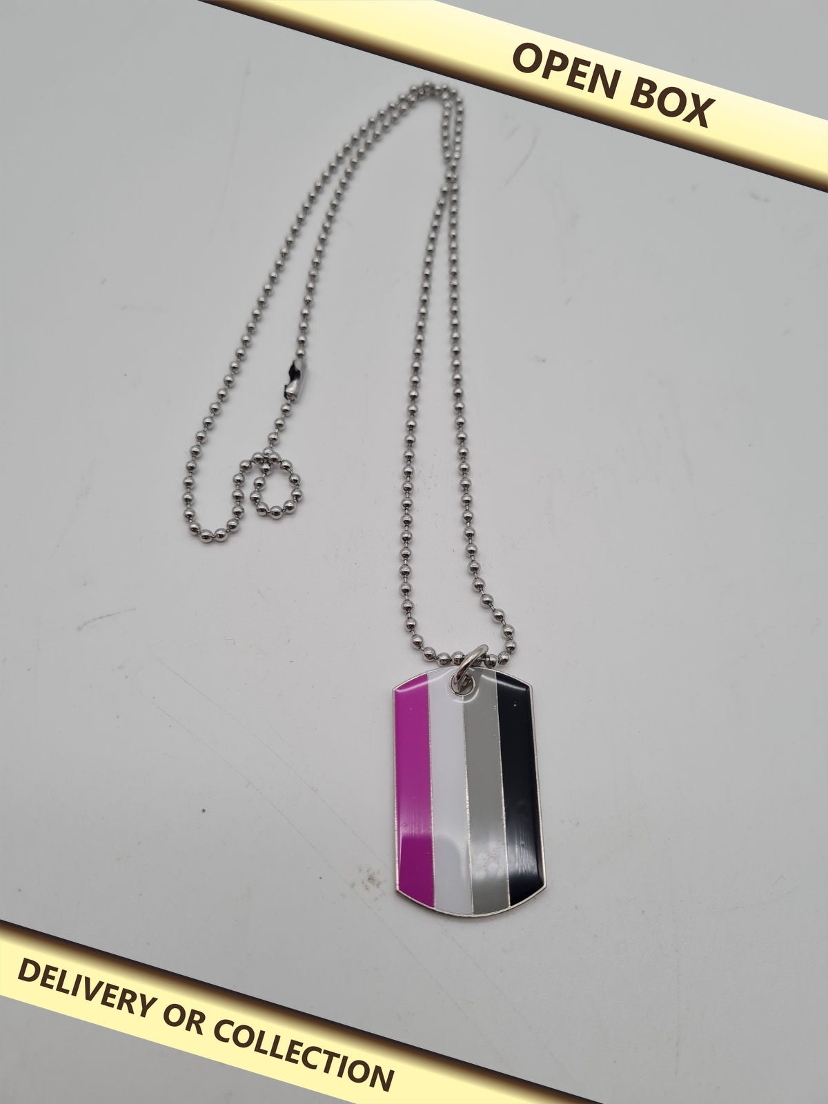 Pride Flag Dog Tag Pendant Necklace — photograph 1 — Open box; auction delivery information shown on image