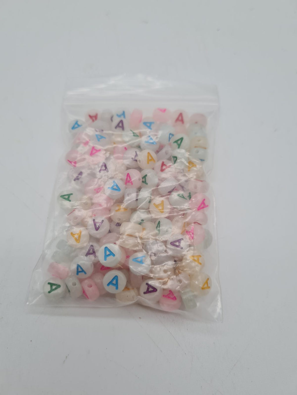 Flat Round Letter A Acrylic Beads — photograph 1