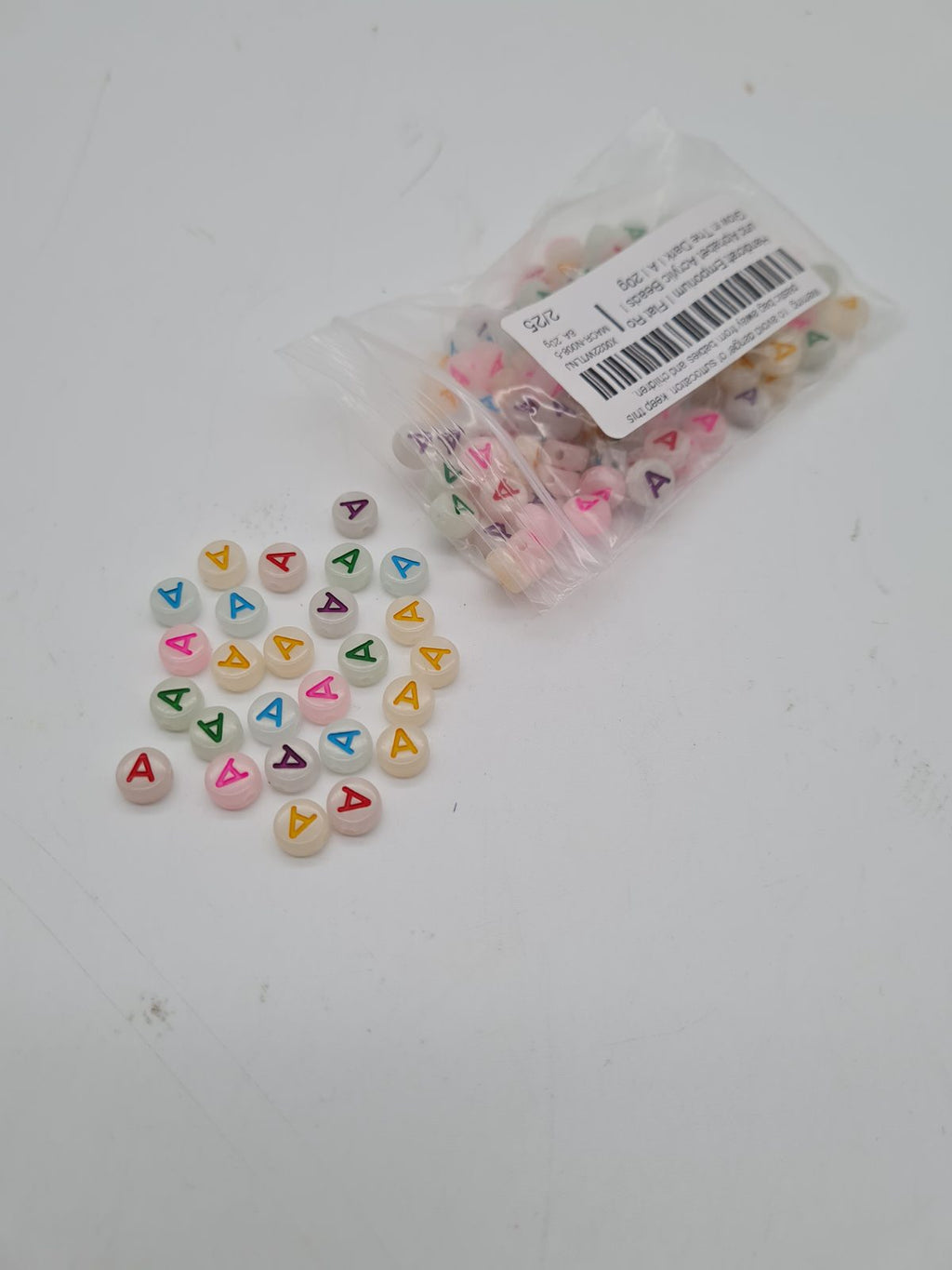 Flat Round Letter A Acrylic Beads — photograph 2