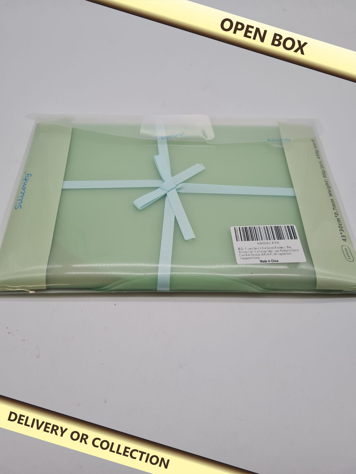 Set of 4 silicone countertop protector mats — photograph 1 — Open box; auction delivery information shown on image