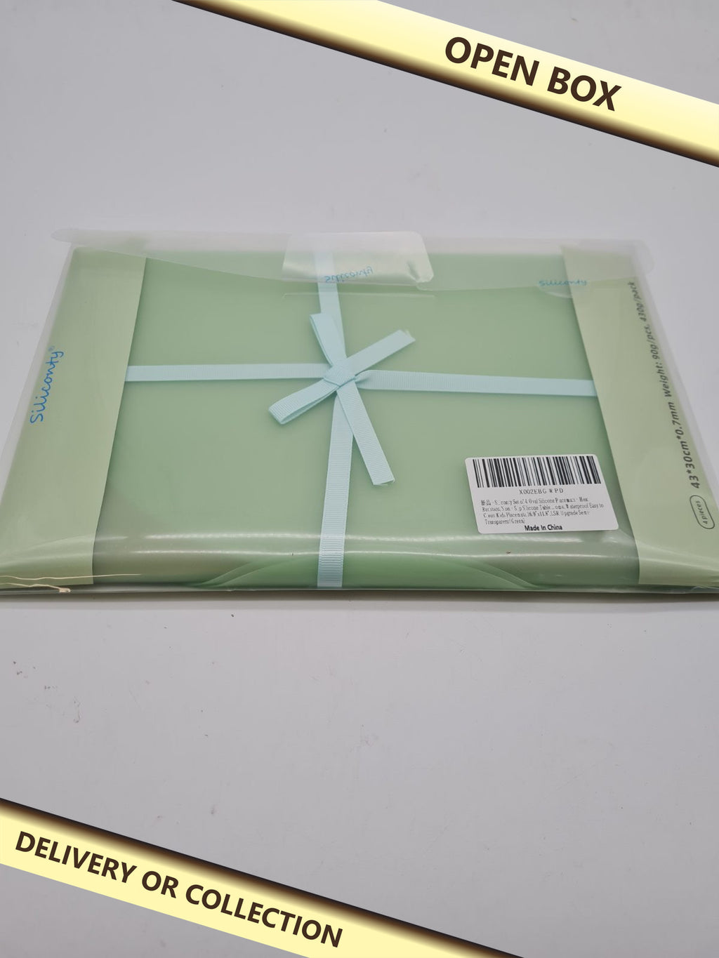 Set of 4 silicone countertop protector mats — photograph 1 — Open box; auction delivery information shown on image