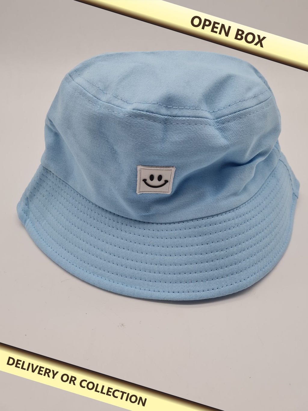 Blue Bucket Hat with Smiley Face Patch — photograph 1 — Open box; auction delivery information shown on image