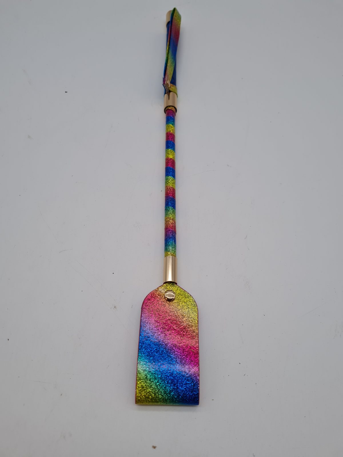 Rainbow Glitter Paddle Riding Crop — photograph 1