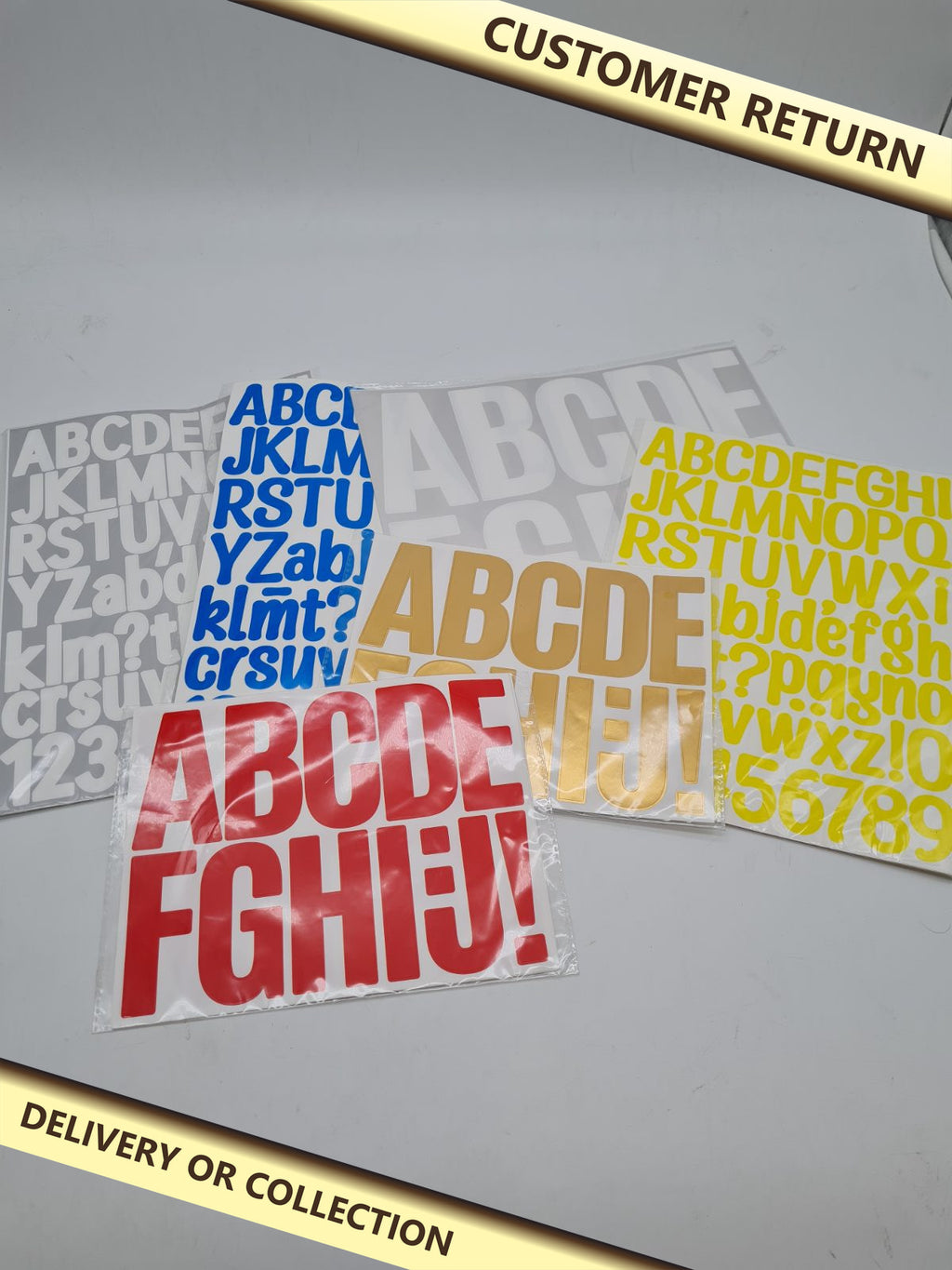 Bundles of alphabet stickers — photograph 1 — Customer return; auction delivery information shown on image