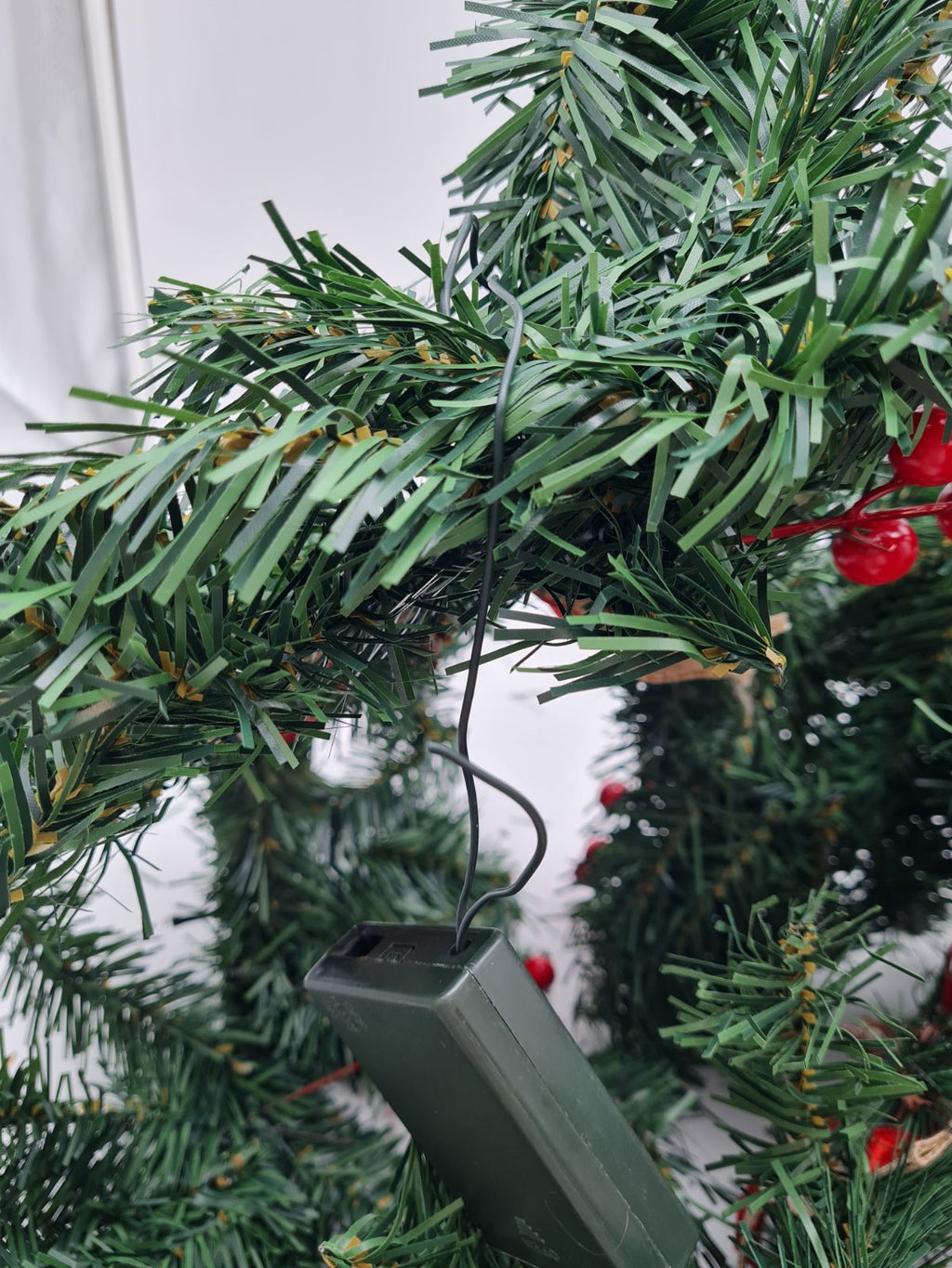 Artificial Christmas garland with pine cones and berries — photograph 2