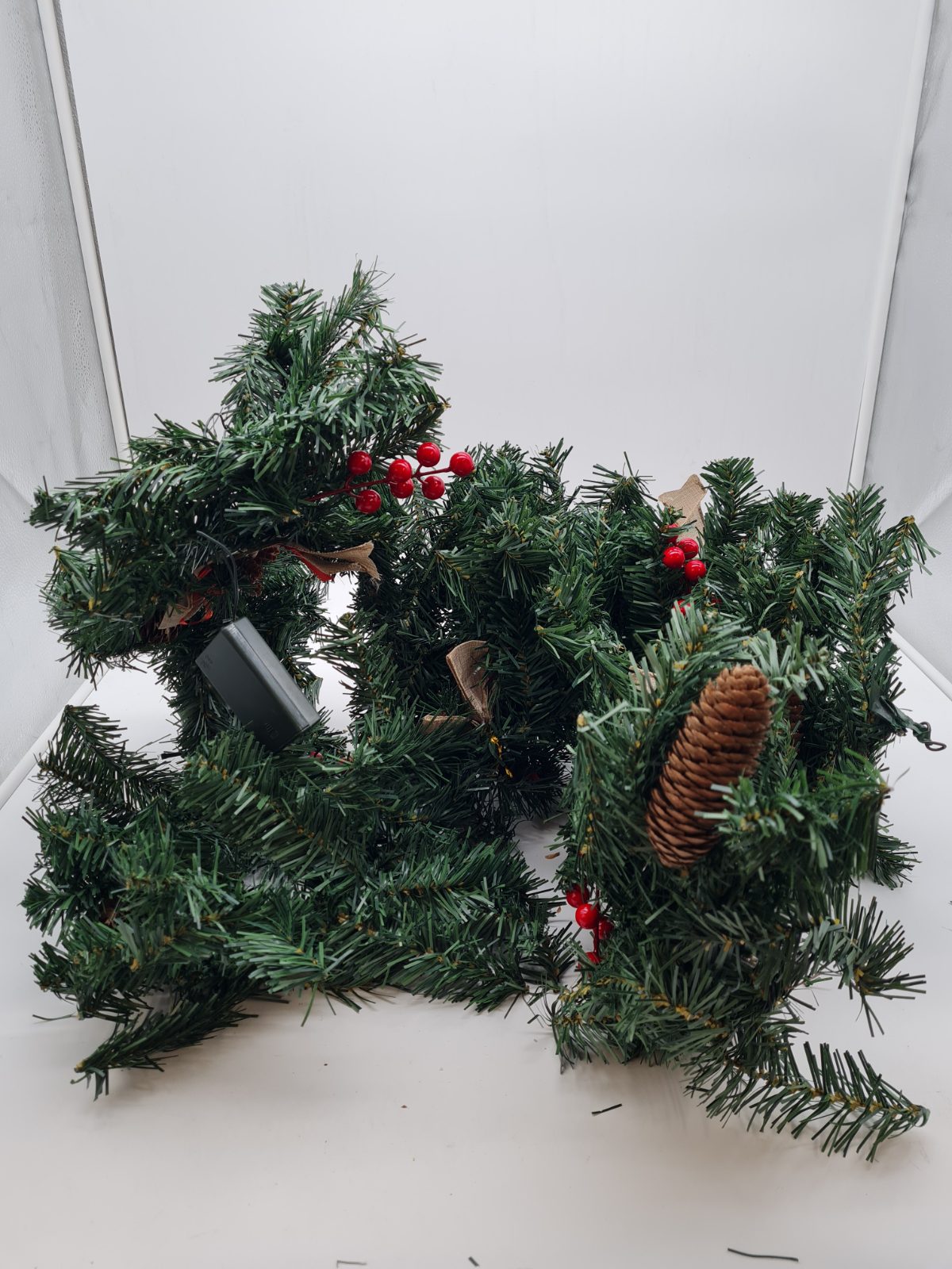 Artificial Christmas garland with pine cones and berries — photograph 3