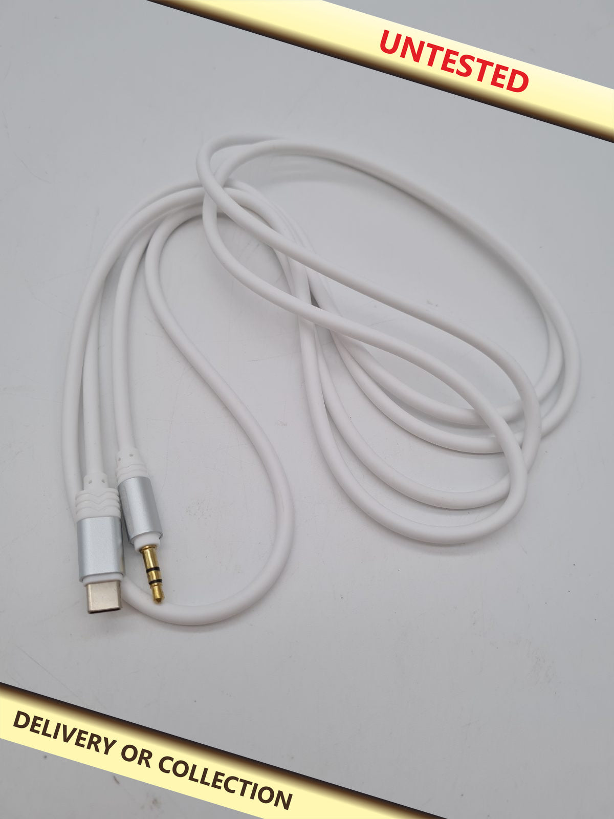 USB-C to 3.5mm audio cable â€” photograph 1 — Untested; auction delivery information shown on image