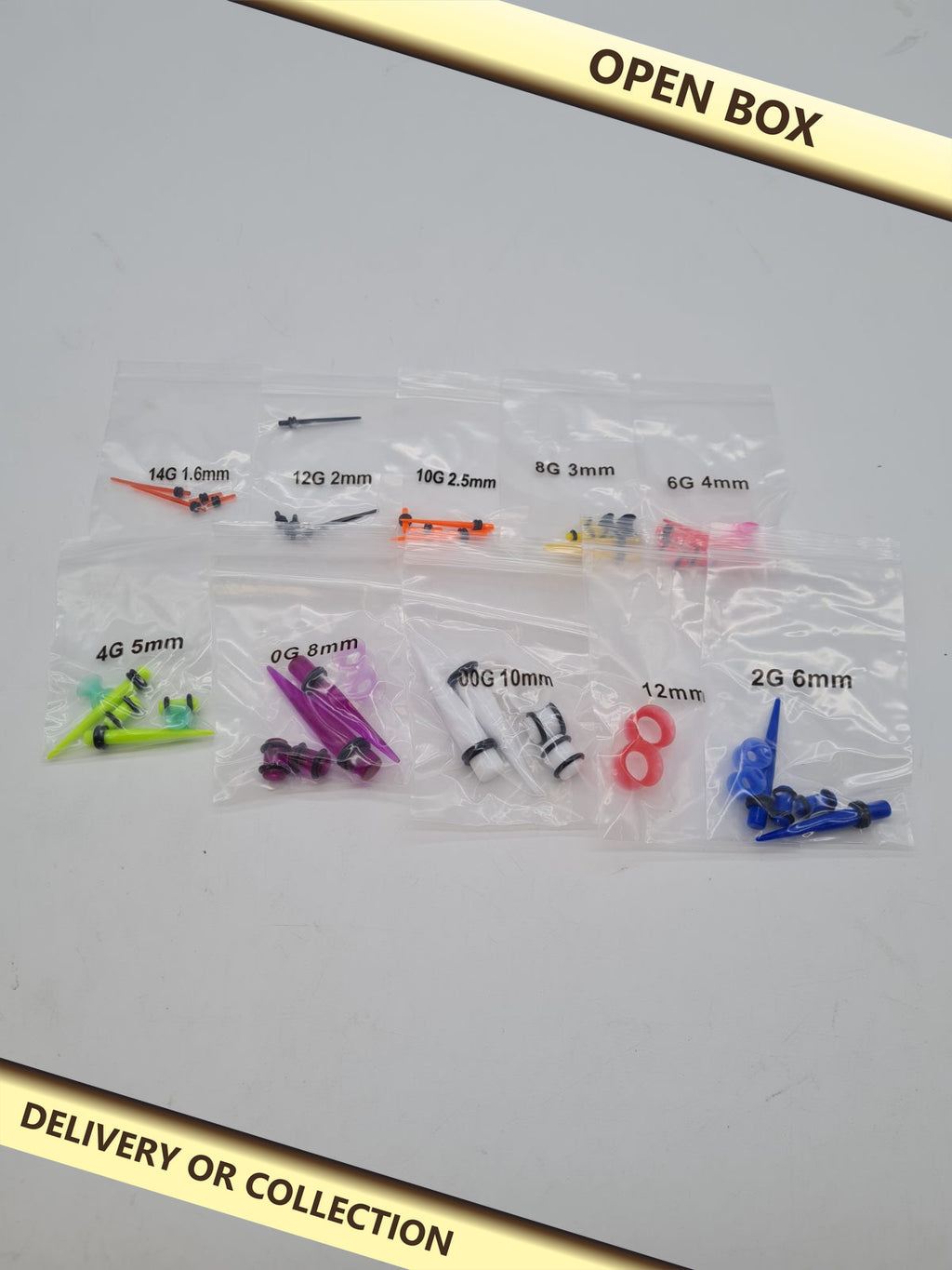Acrylic Ear Stretching Taper and Plug Set — photograph 1 — Open box; auction delivery information shown on image