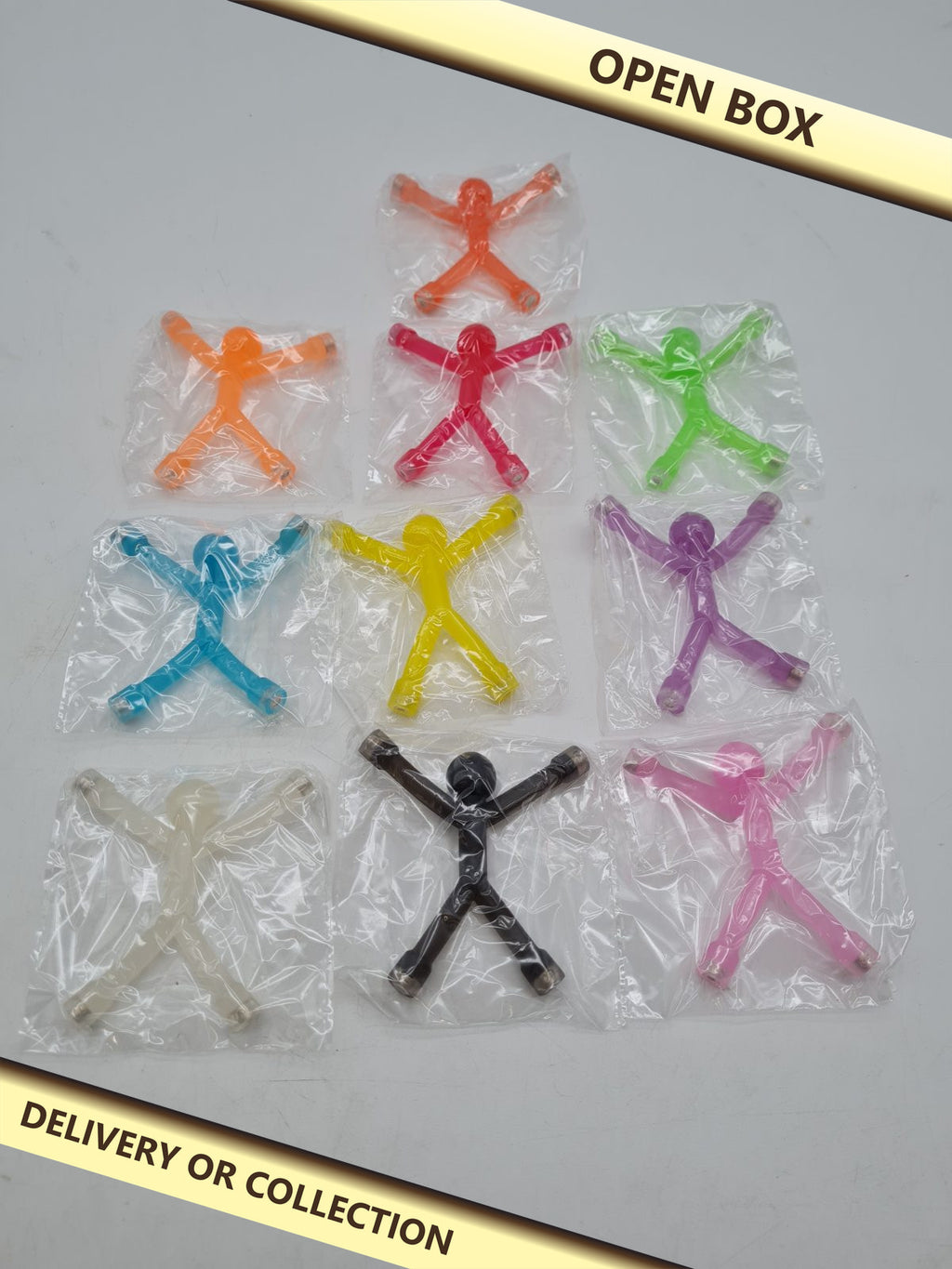 10-Piece Magnetic Mini Man Toy Set — photograph 1 — Open box; auction delivery information shown on image