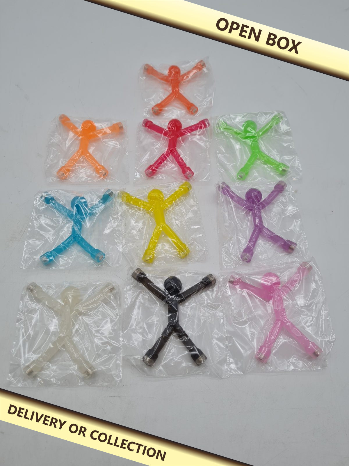 10-Piece Magnetic Mini Man Toy Set — photograph 1 — Open box; auction delivery information shown on image