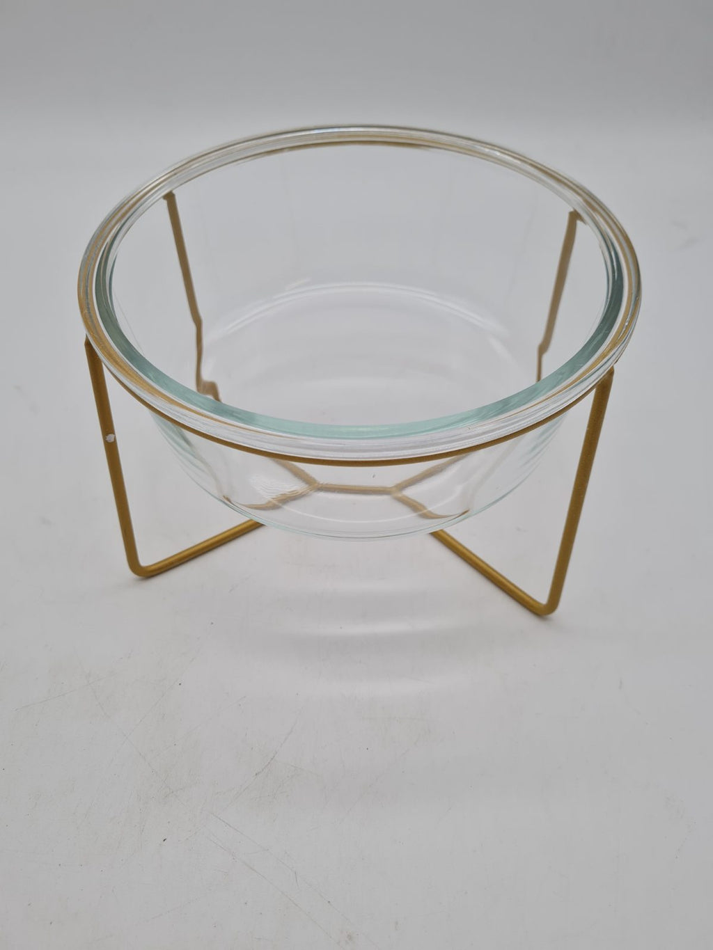 Glass pet feeding bowl with raised metal stand — photograph 1