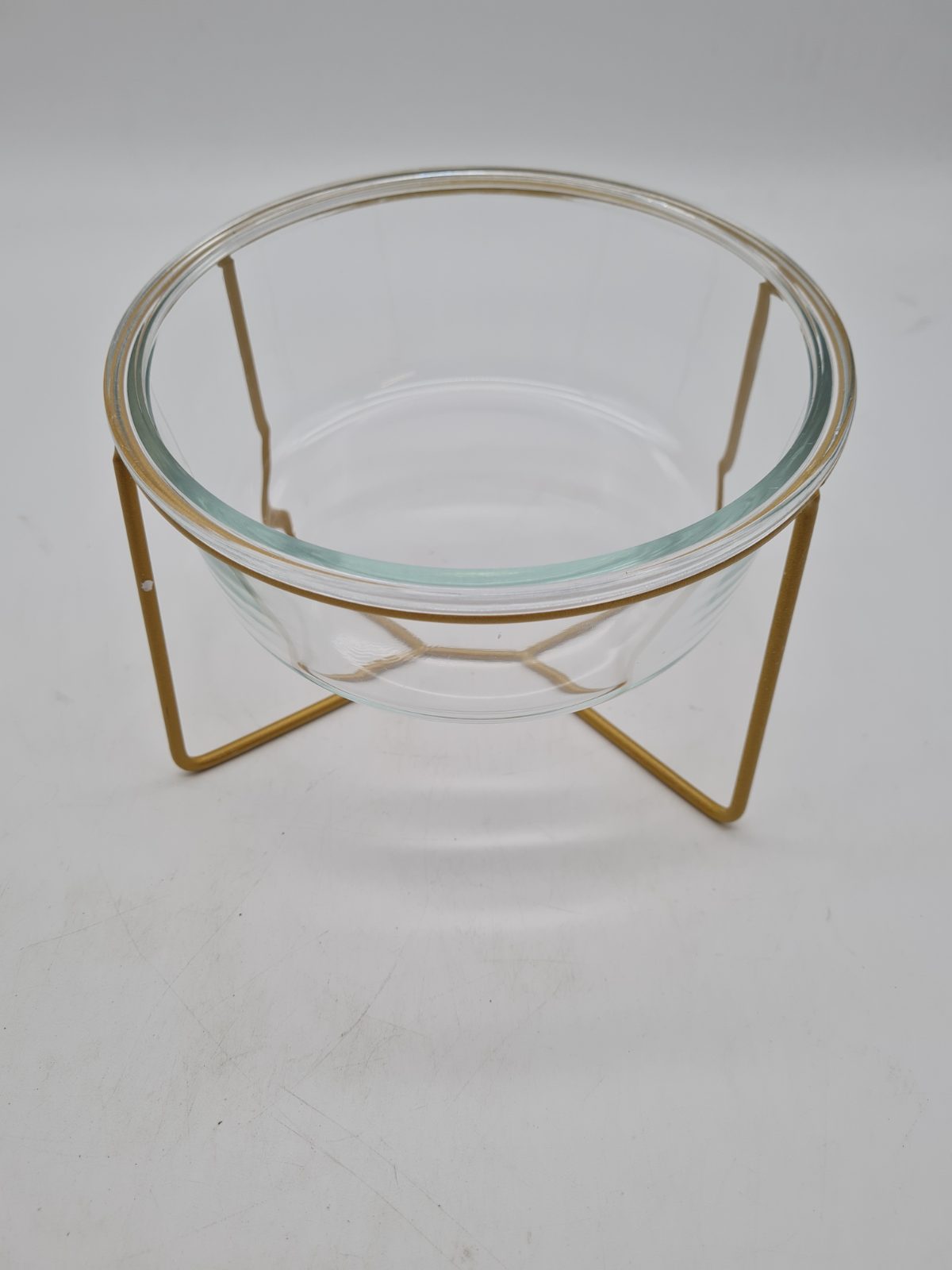 Glass pet feeding bowl with raised metal stand — photograph 1
