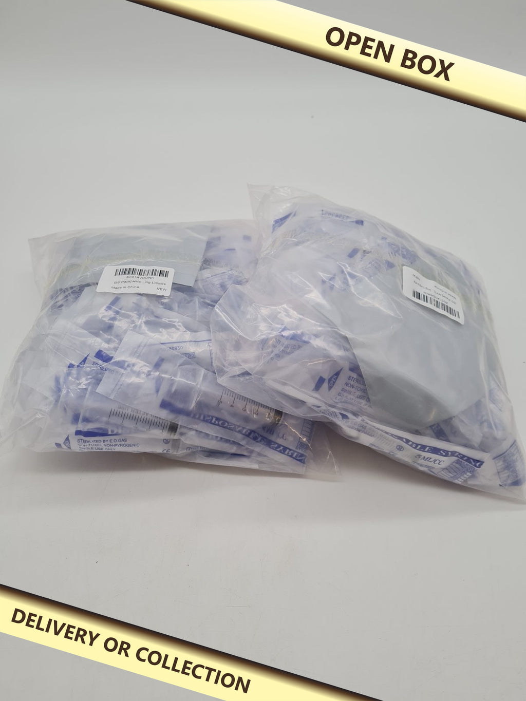 5 ml/cc Disposable Syringes 2 packs â€” photograph 1 — Open box; auction delivery information shown on image