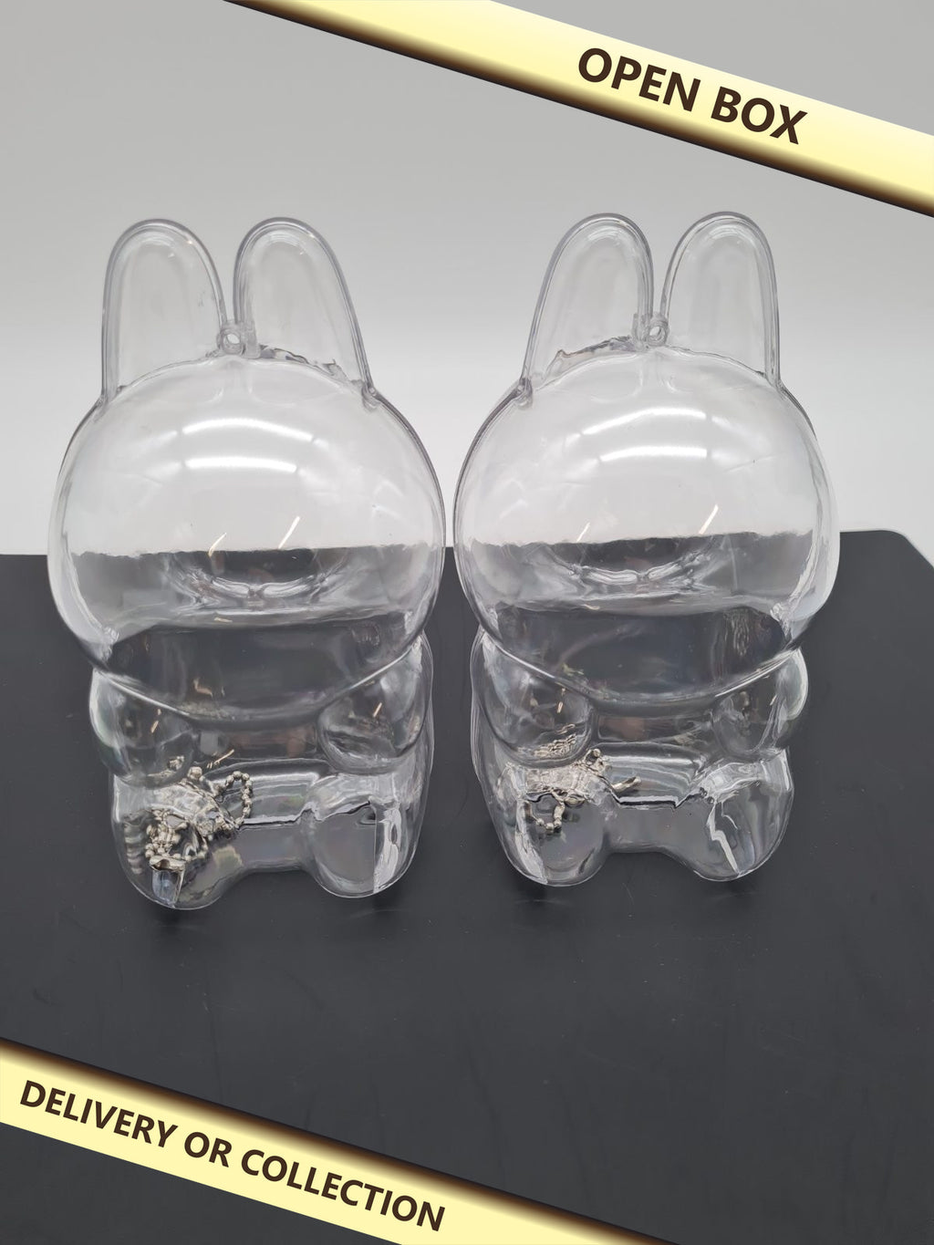 Rabbit-Shaped Mini Figure Display Case 2 pack â€” photograph 1 — Open box; auction delivery information shown on image