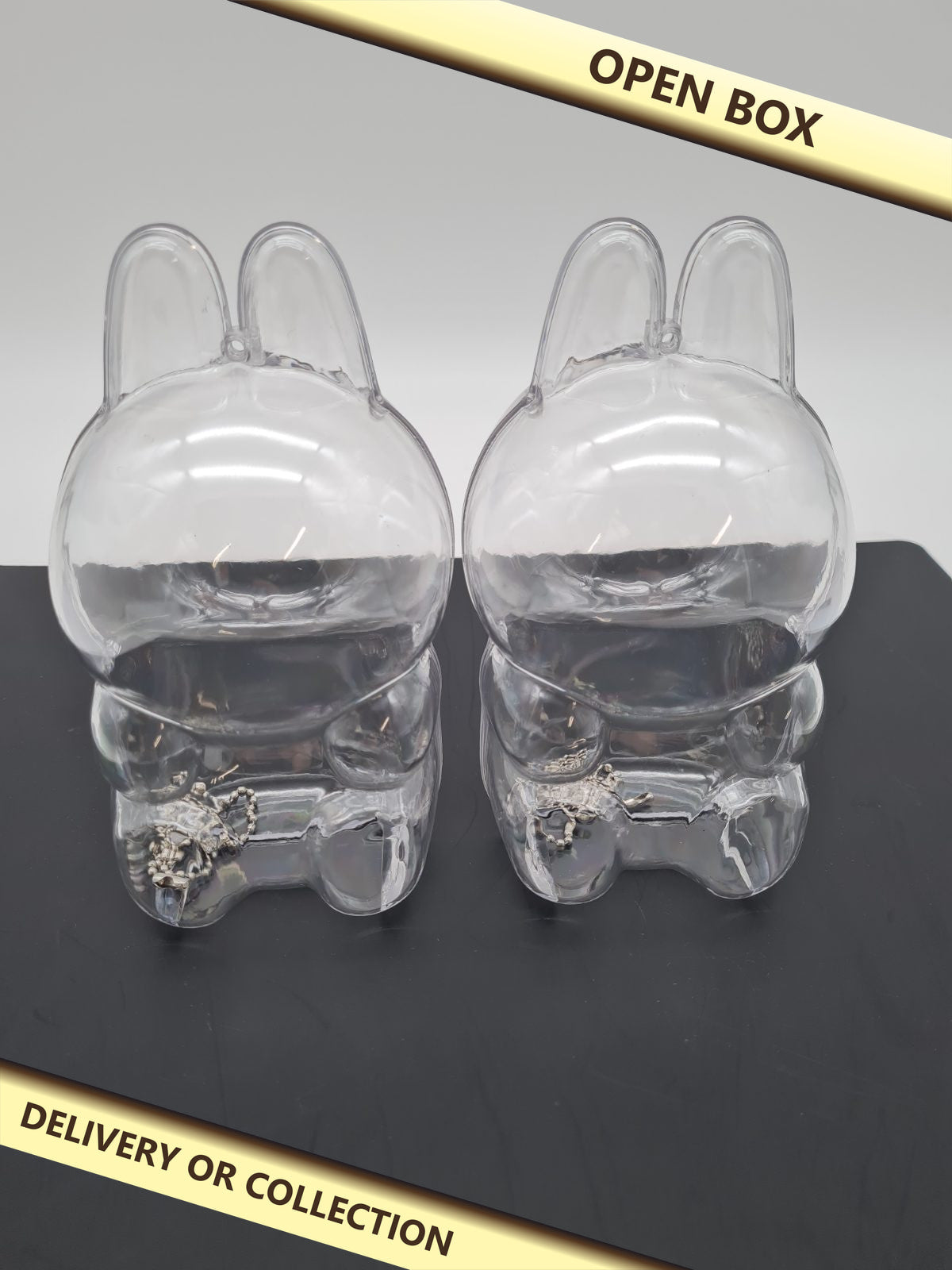Rabbit-Shaped Mini Figure Display Case 2 pack â€” photograph 1 — Open box; auction delivery information shown on image
