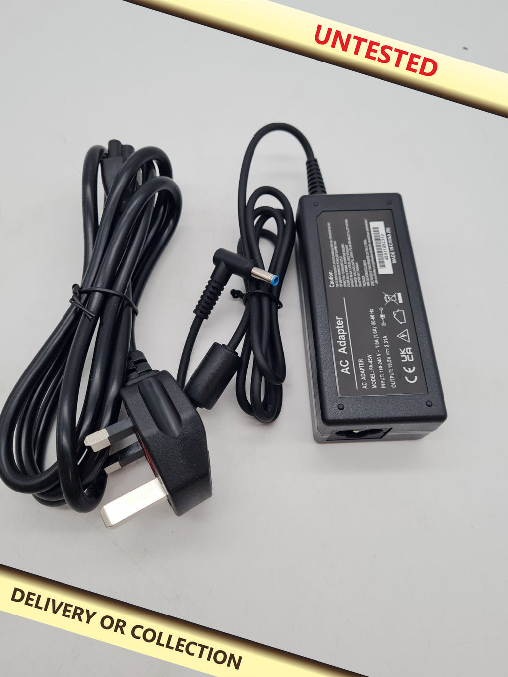 Laptop AC Adapter PA-45W â€” photograph 1 — Untested; auction delivery information shown on image