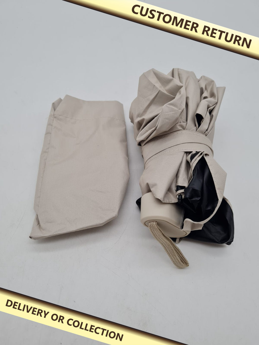 Compact Folding Umbrella â€” photograph 1 — Customer return; auction delivery information shown on image